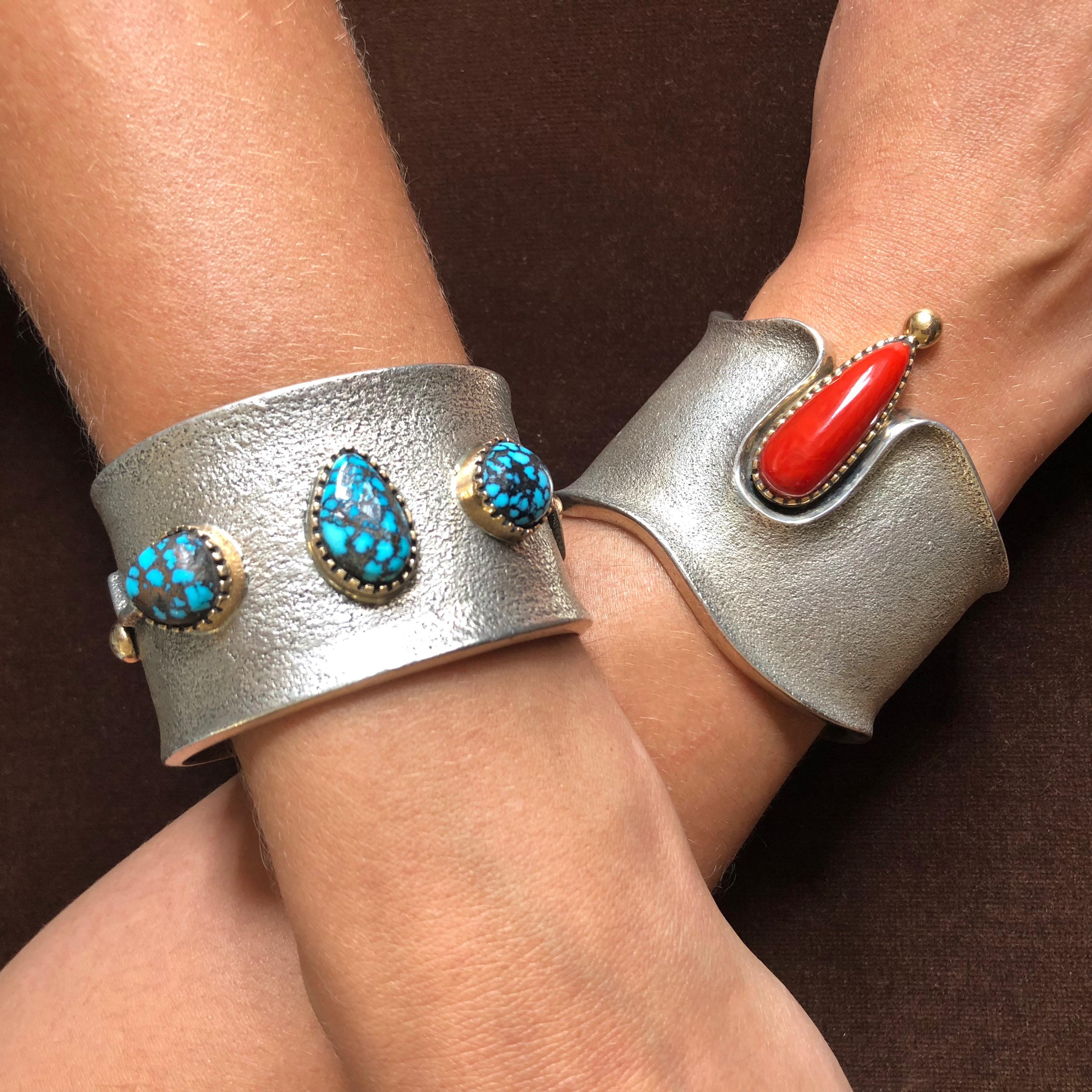 Three gold bezel set cabochon Lander turquoise, 14 karat yellow gold and tufa cast sterling silver cuff by Navajo artist Edison Cummings, 2015.  The inside of the cuff measures 5.5″ with a 1″ opening and it is 1.5