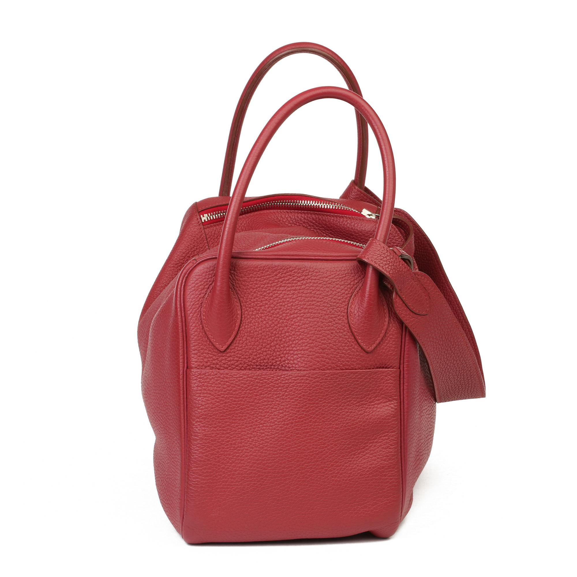 HERMÈS
Rubis Clemence Leather Lindy 34cm 

Serial Number: T
Age (Circa): 2015
Authenticity Details: Date Stamp (Made in France) 
Gender: Ladies
Type: Tote, Shoulder

Colour: Rubis
Hardware: Palladium 
Material(s): Clemence Leather
Interior: Red