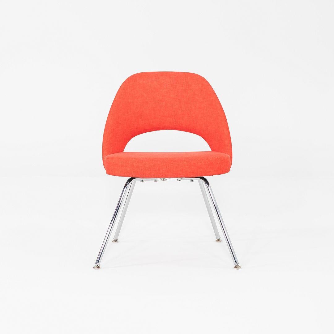 Il s'agit d'une paire de chaises d'appoint Saarinen, conçues à l'origine par Eero Saarinen en 1957. Ces exemples particuliers ont été produits par Knoll aux États-Unis en 2015. Les chaises sont dotées d'une assise rembourrée en tissu rouge-orange et