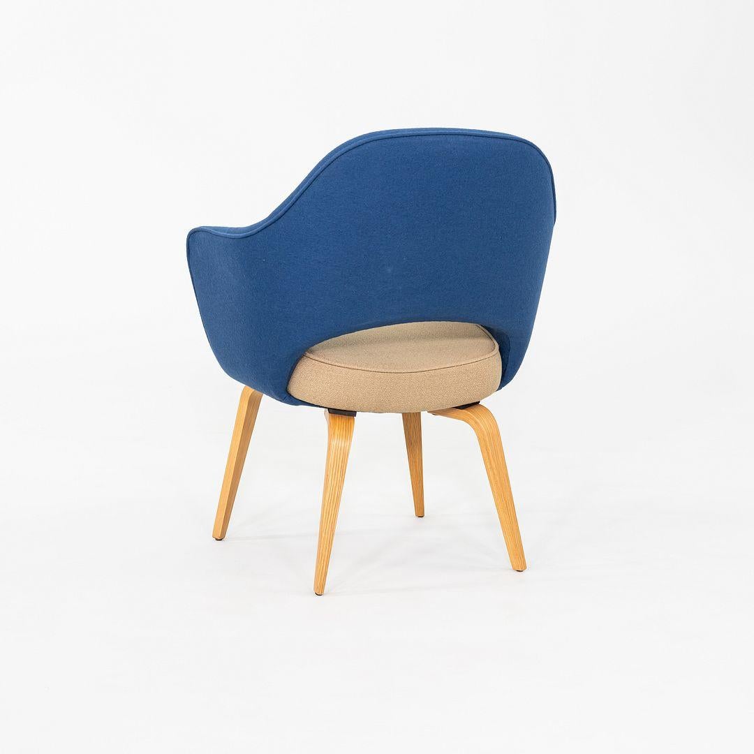 This is a pair of Saarinen Executive Armchairs, designed by Eero Saarinen for Knoll International in 1950. These examples were produced in the USA in 2015. These pieces feature upholstered seats in blue and tan two-tone fabric , and their legs are