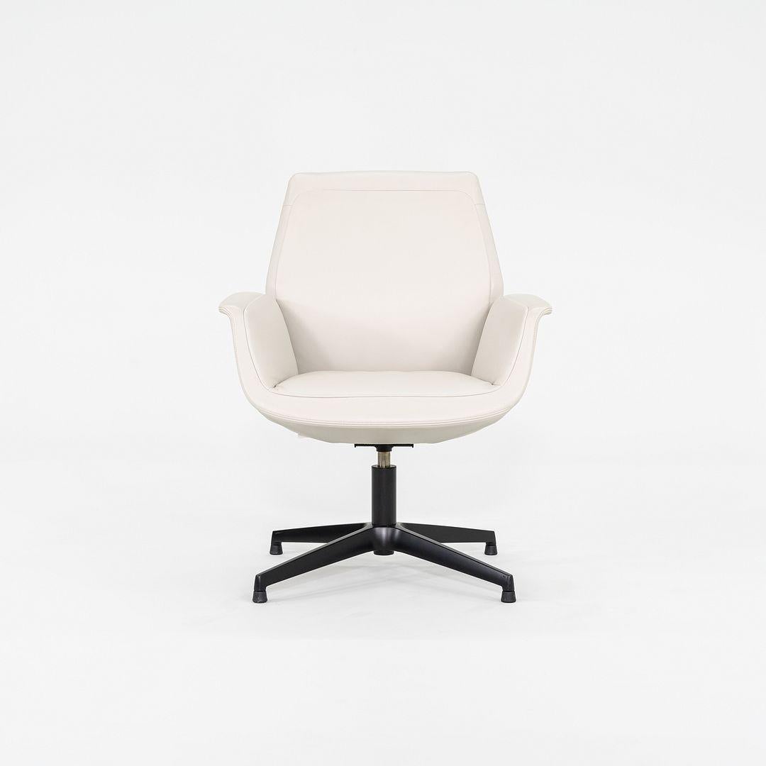 This is a pair of Downtown Visitor Swivel Armchairs, initially designed by Jean-Marie Massaud for Poltrona Frau in 2012. This pair was produced in Italy in 2015. They feature fine Stucco Pelle Frau pebbled leather upholstery, and have black