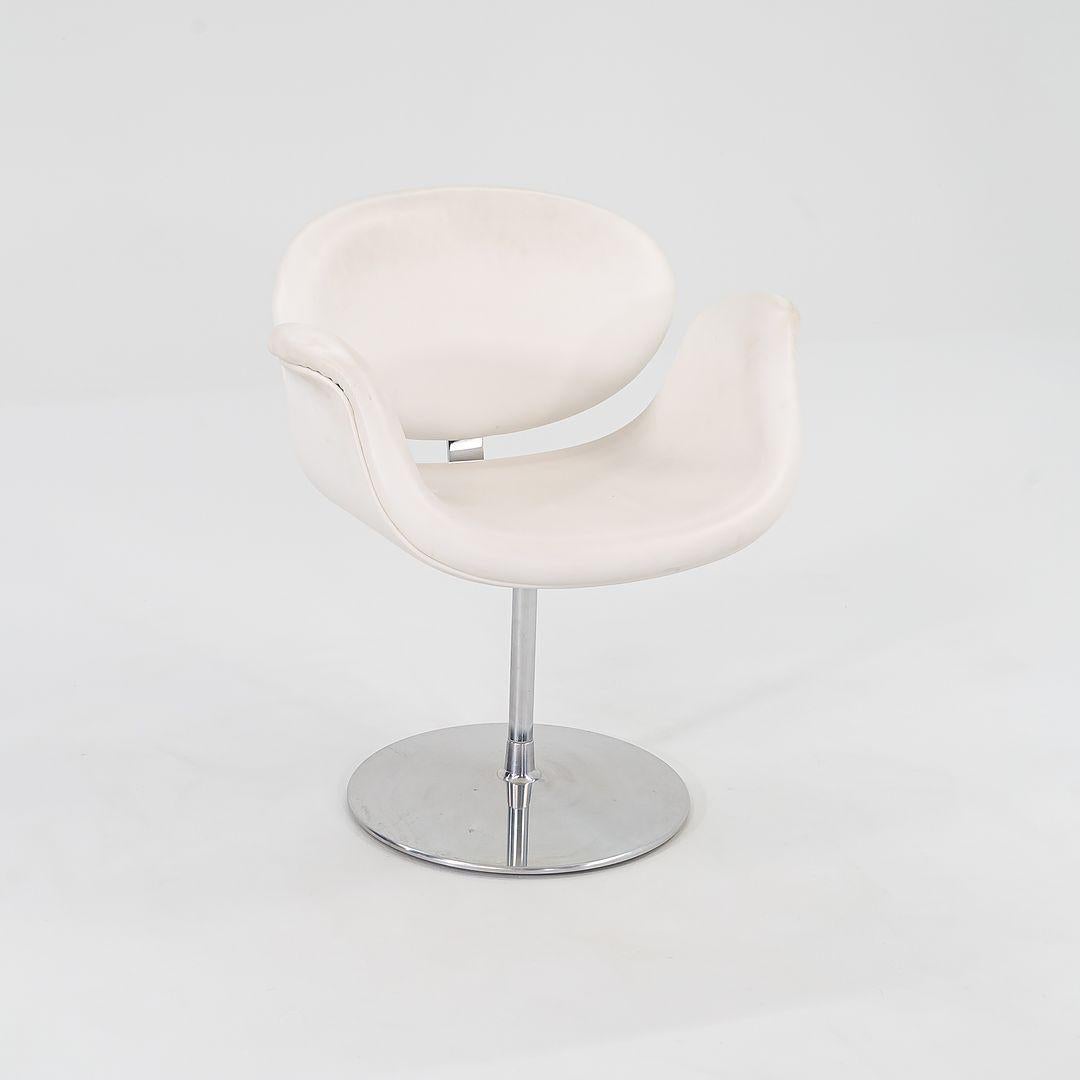 Il s'agit d'un fauteuil Little Tulip original, conçu par Pierre Paulin pour Artifort en 1965. Cet exemplaire date de 2016 et a été produit en Belgique. Le meuble est doté d'une base pivotante en aluminium poli et d'un revêtement en cuir blanc