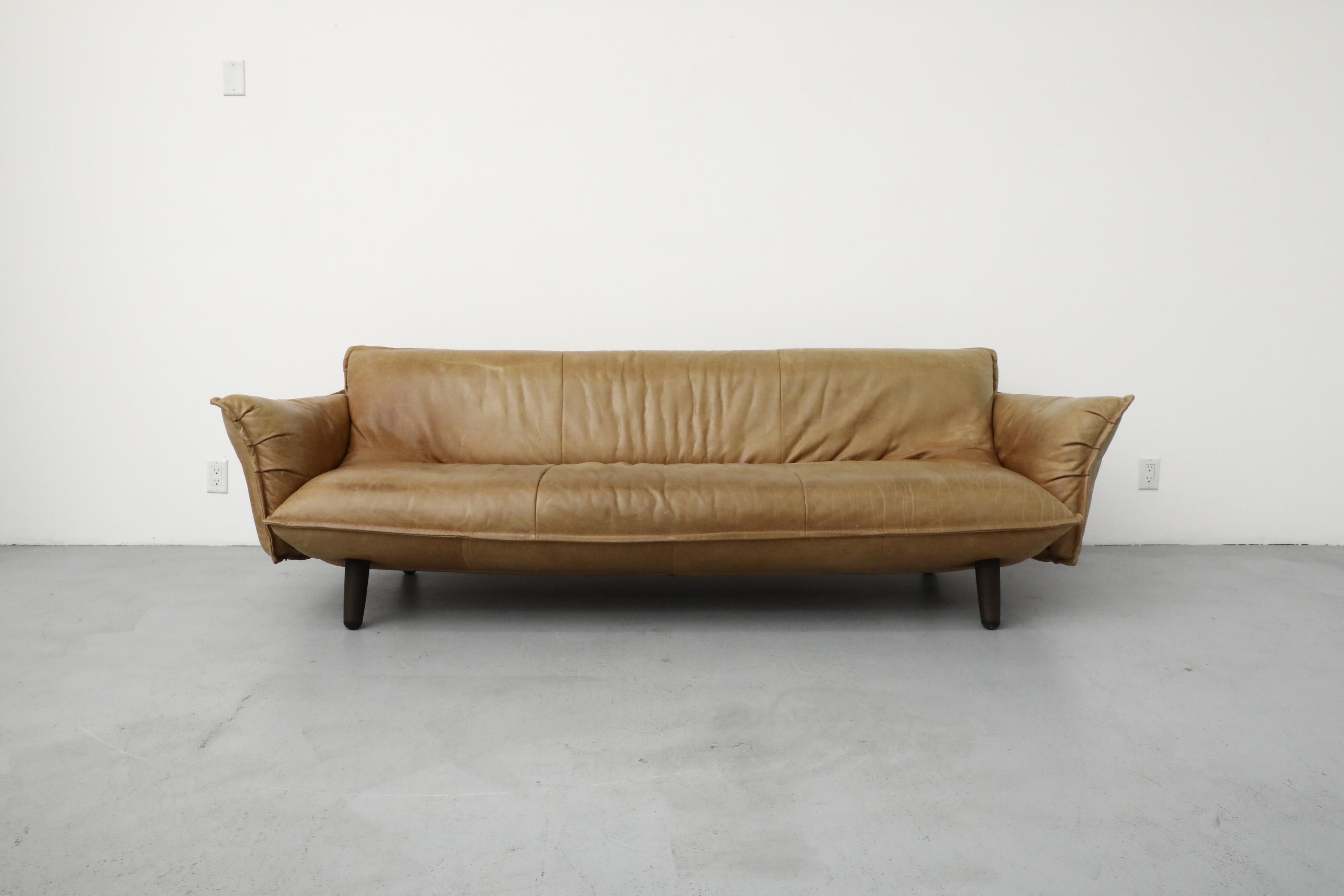 The 'Swoon' is a stunning natural leather 3 seater sofa with swooping lines and inviting open arms. Designed in 2016 by Innovative Dutch designer Gerard Van Den Berg in collaboration with his son Ivo for his brand, Label. In original condition with