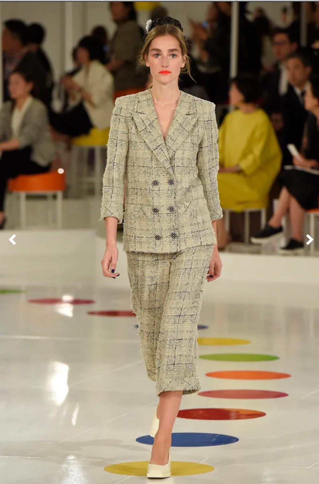 This 2016 Resort Runway CHANEL tweed jacket is crafted of tweed fabric in beige/black check pattern featuring a double-buttoned front and patch pockets. Luxurious and very soft to touch tweed. Chanel signature chained hemline. Made in France. Size