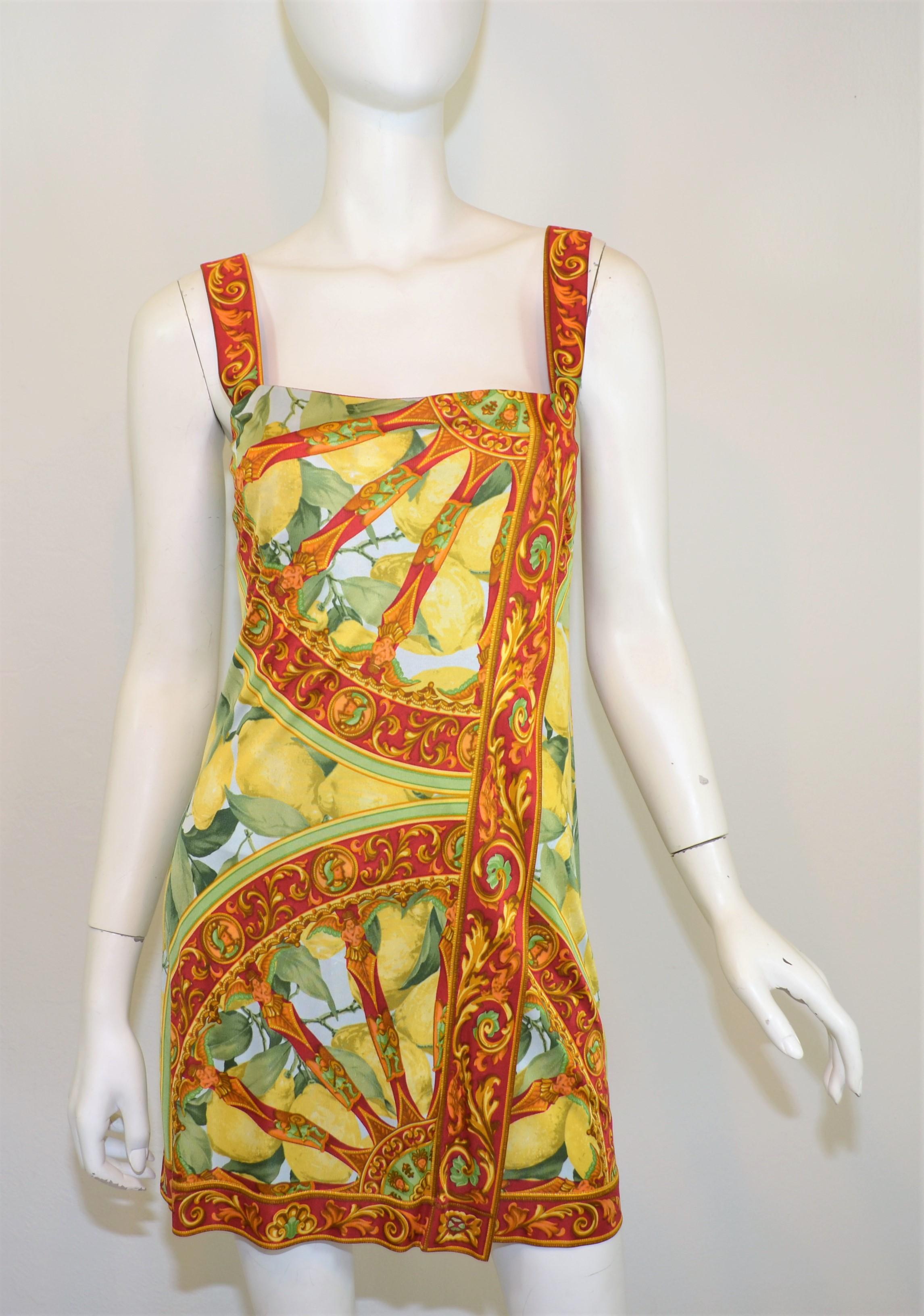 Dolce & Gabbana lemon print mini dress featured with a wine red border and playful lemon print throughout. Dress is labeled a size 42, made in Italy. 100% viscose.

Measurements:
bust 33''
waist 28'' 
hips 36''
length 24''