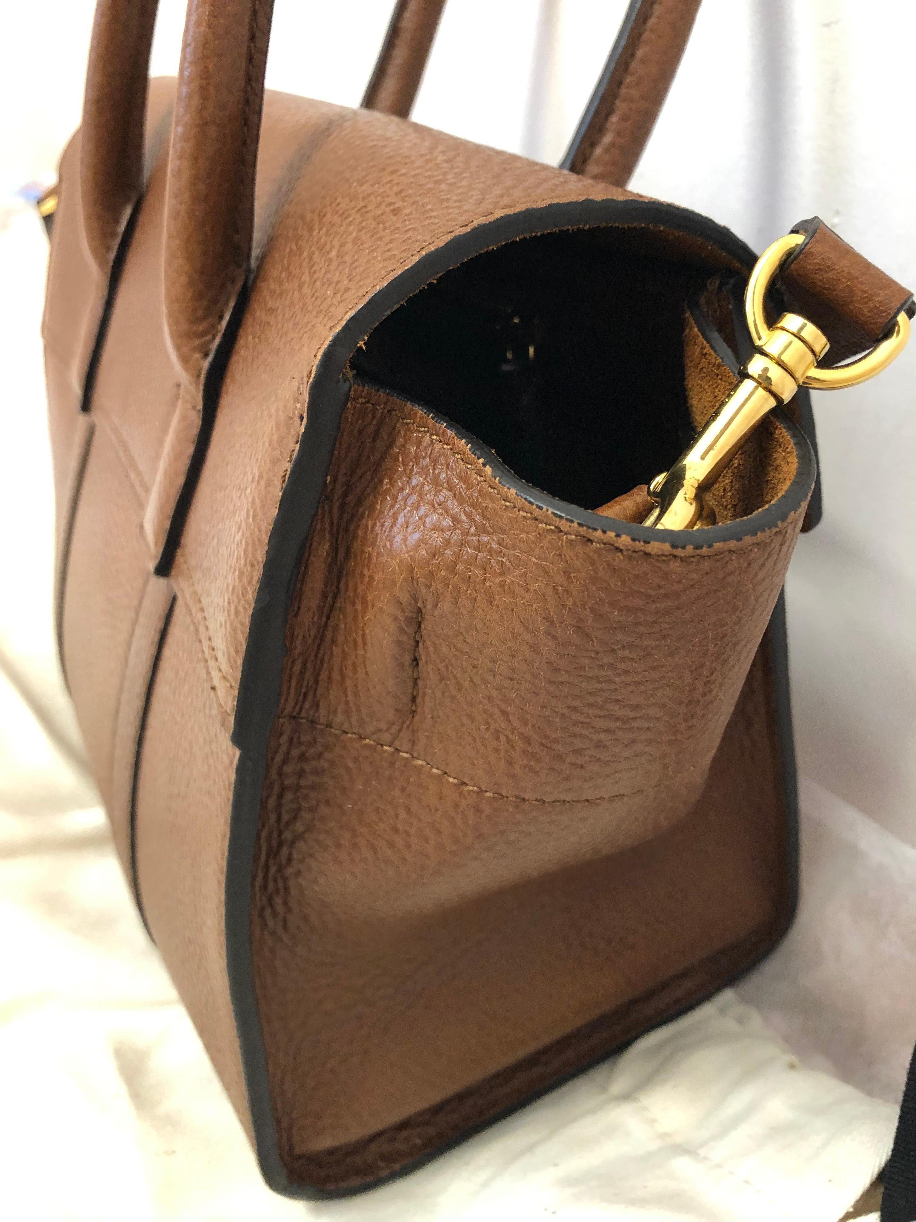 This bag is so elegant, it can be worn crossbody or top handle. The color is oak and the leather natural grain. It is a 2017-18 but in immaculate condition. It is a reprise of 2003 Mulberry Bayswater and designed by Johnny Coca. 
The bag has a suede