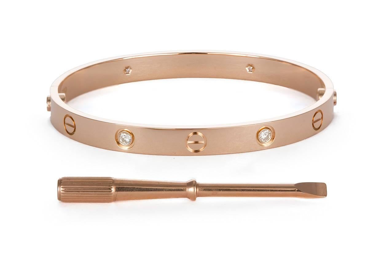 We are pleased to offer this Authentic 2017 Cartier 18K Rose Gold 4 Diamond Love Bangle Bracelet Size-17. It was originally purchased in October 2017 and features the new style screw system. It comes complete with it's original factory screw driver,