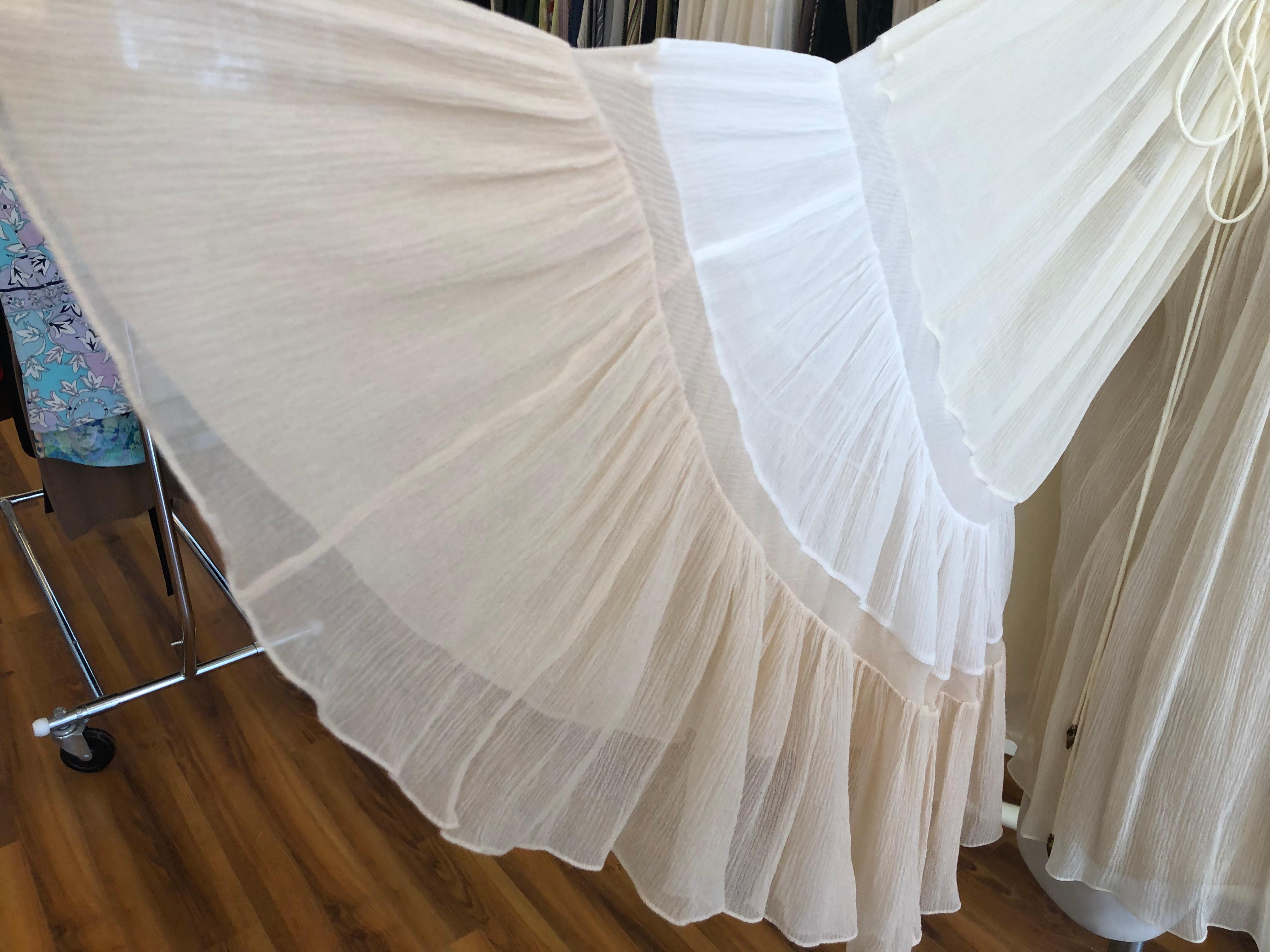 Beautiful fluted pleats blouse which can be worn off the shoulder. It is crafted of very light silk crepon in soft cream, white and peach, The sleeves are a statement - Please look at the pictures. The bell sleeves are exaggerated, and there are