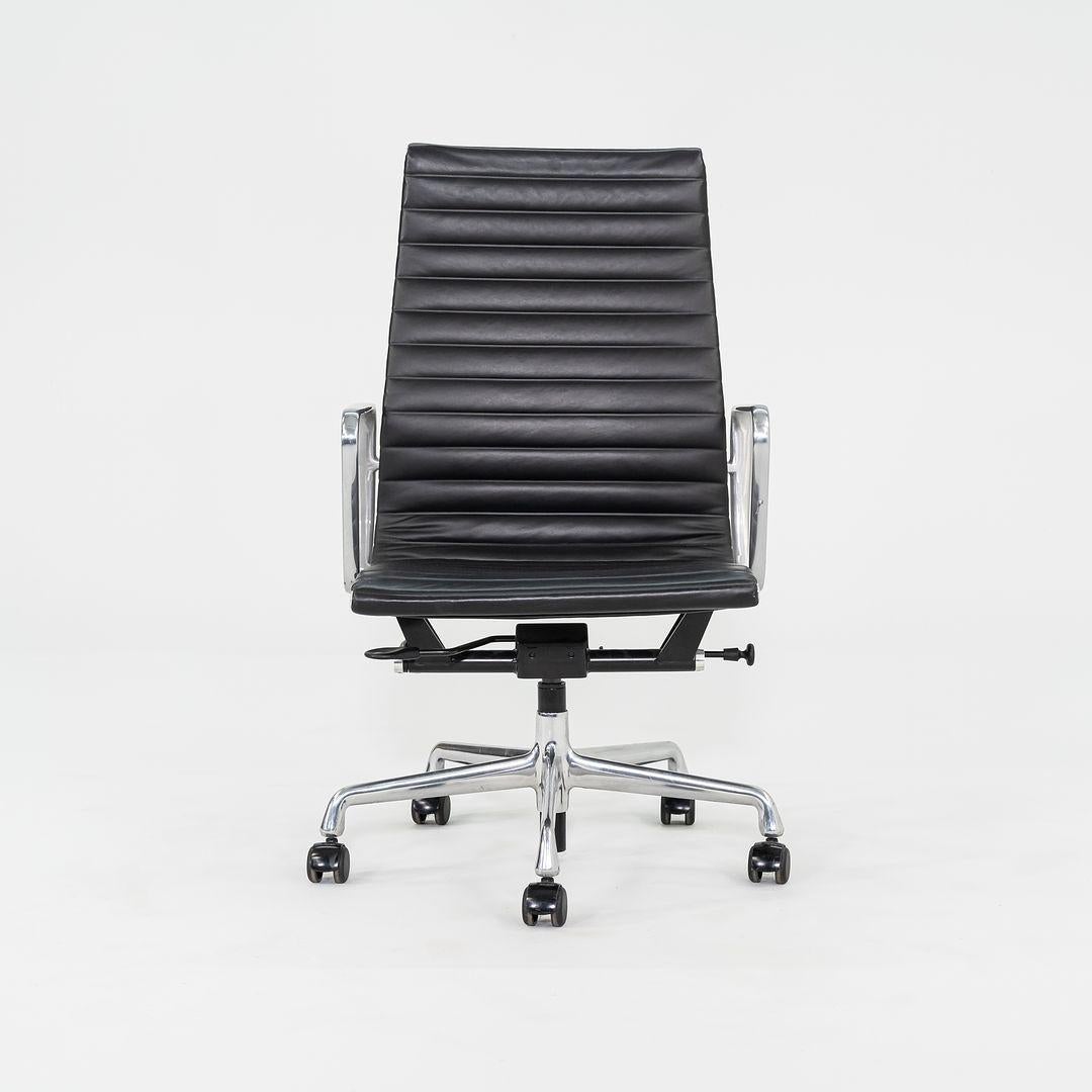 These are Eames Aluminum Group Executive high back desk chairs, designed by Charles and Ray Eames and produced by Herman Miller. This model was originally designed in 1958, and these examples were produced in 2017. The chairs are upholstered in