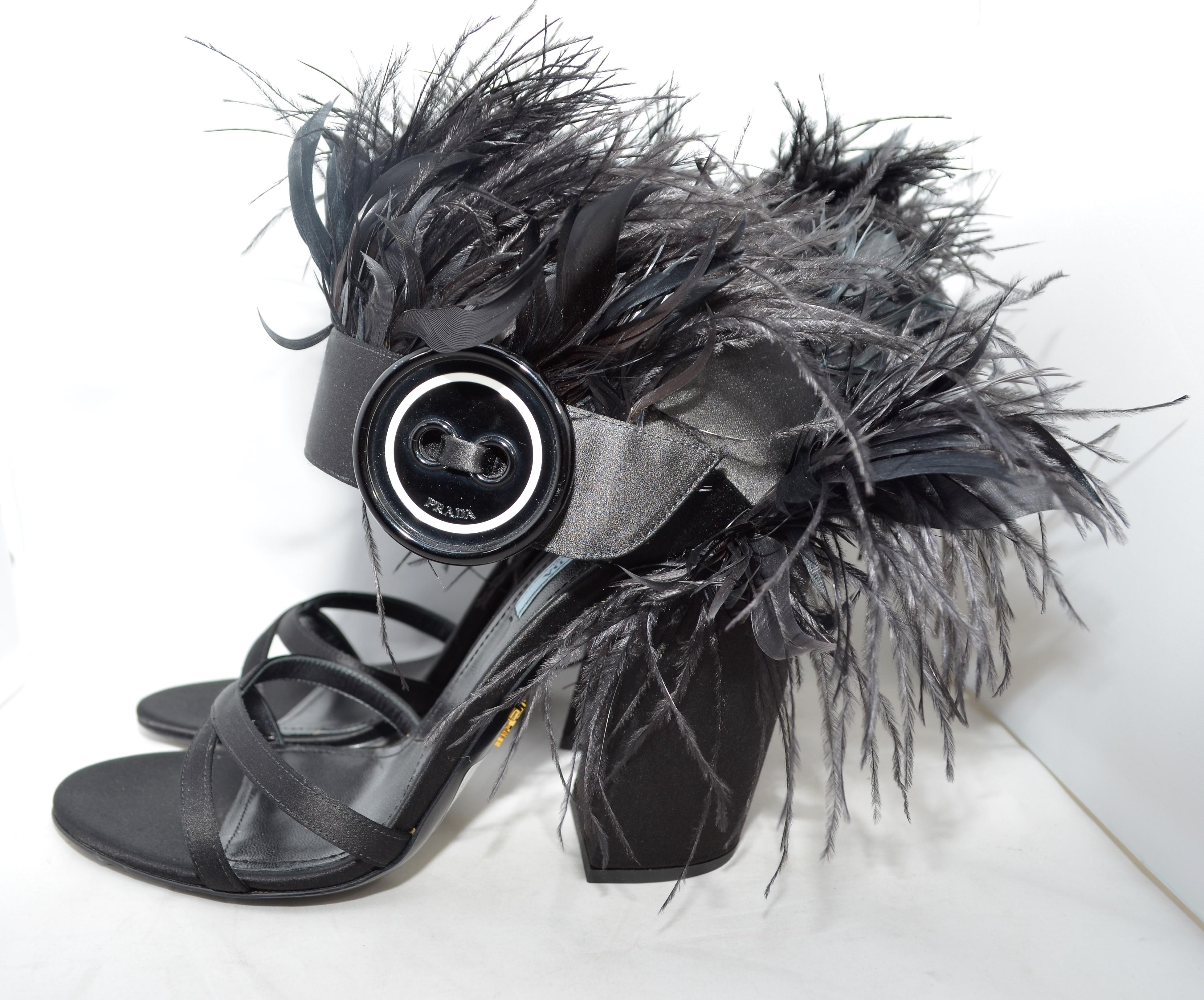 From the Fall 2017 Collection, these Prada sandals are featured in black with satin and feather trims featuring button accent at uppers and covered heels. Size 41, made in Italy.

Heel height - 5''
Excellent condition!