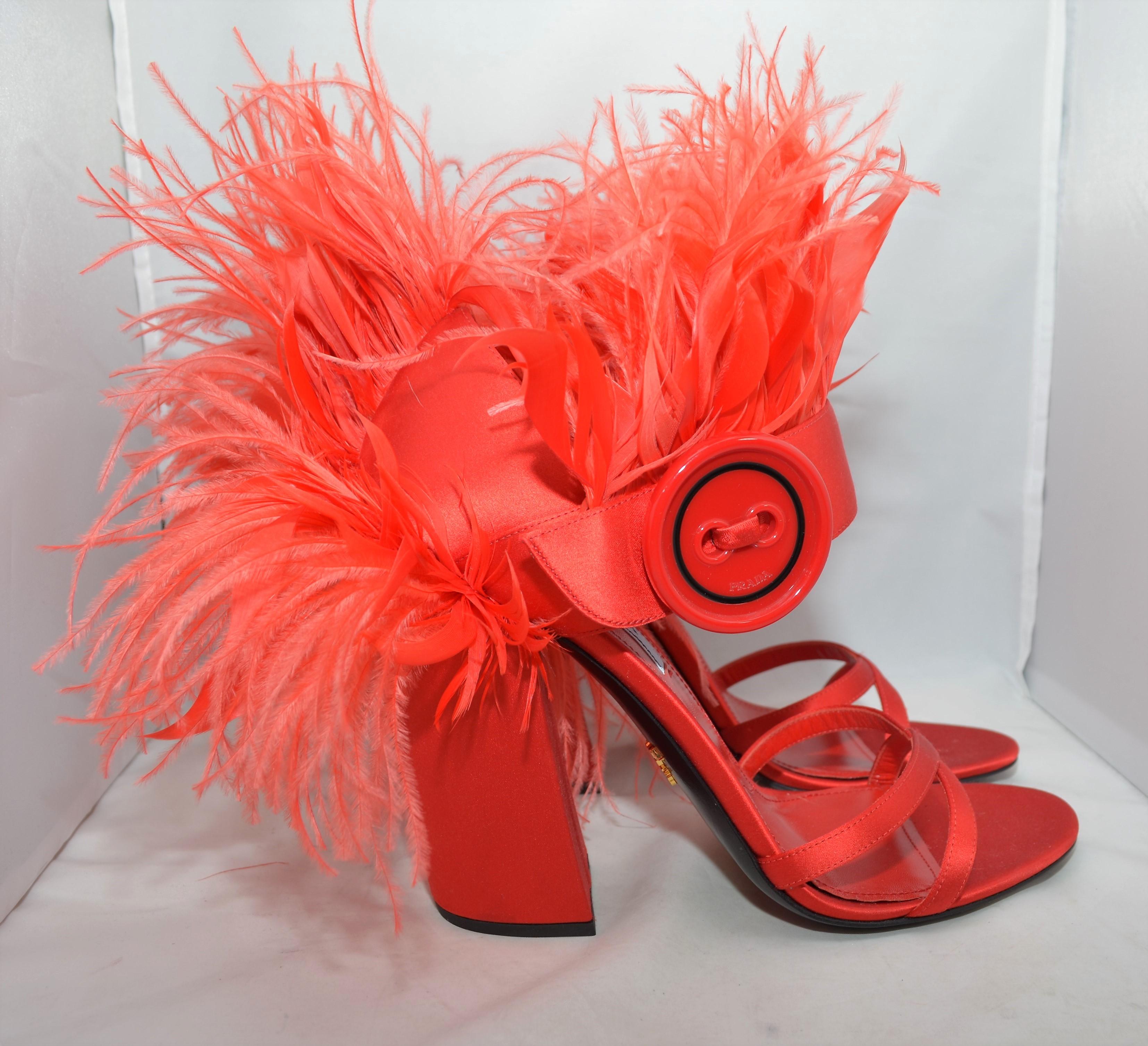 From the Fall 2017 Collection, Prada sandals are featured in red with satin and feather trims featuring button accent at uppers and covered heels. Size 41, made in Italy.

Heel height - 5''
Excellent condition!
