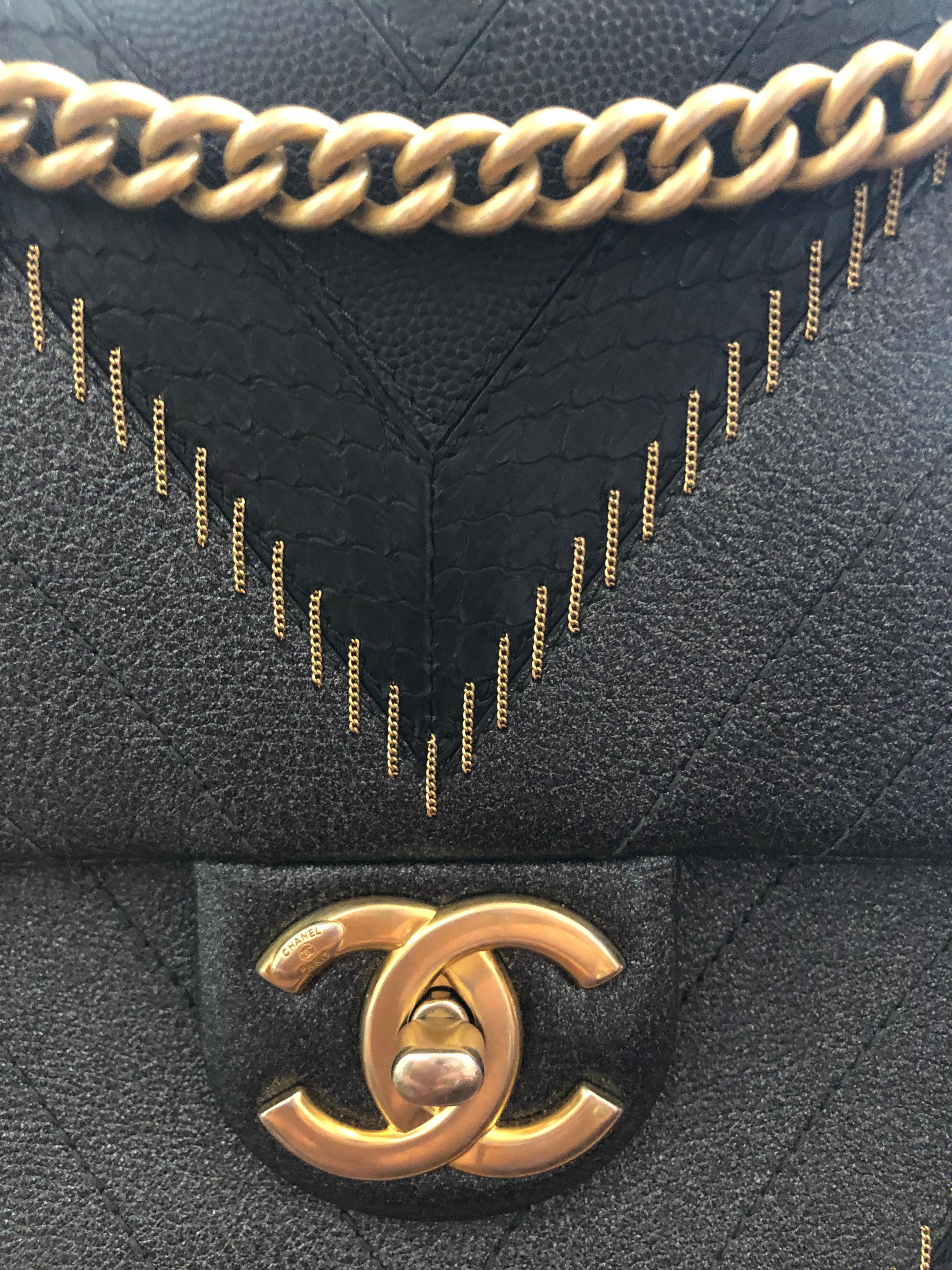 Snag yourself some rare Chanel with this amazing limited edition bag! Circa 2017, this rare find features Chevron stitching crafted from iridescent blue leather, black python, and Chanel's signature black caviar leather. Includes delicate gold