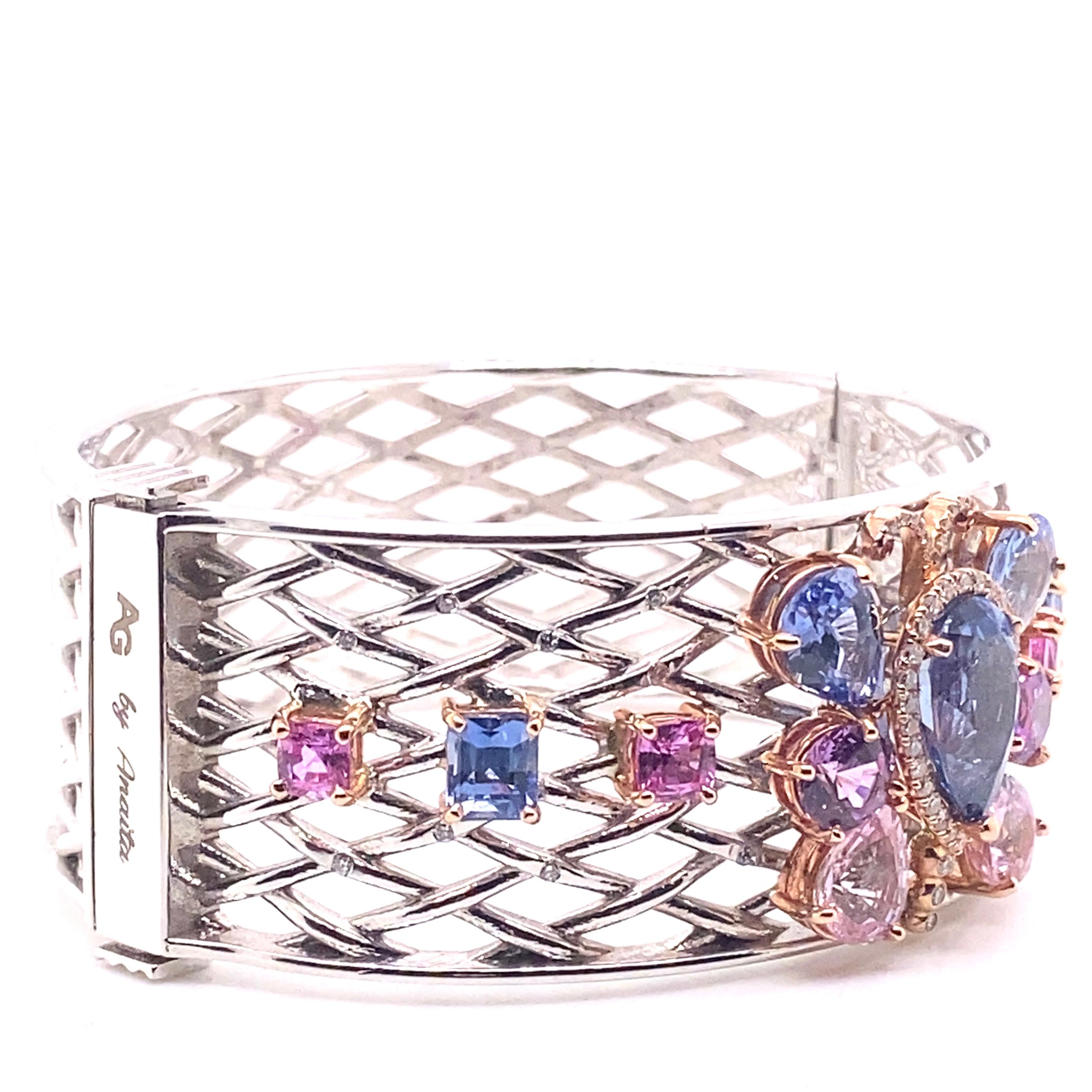 An 18 karat white gold open lattice hinged cuff bracelet featuring GIA certified natural blue, pink, and purple sapphires totaling 20.17 carats set in 18 karat rose gold. The middle sapphire is surrounded .41 carats of round diamonds. The main