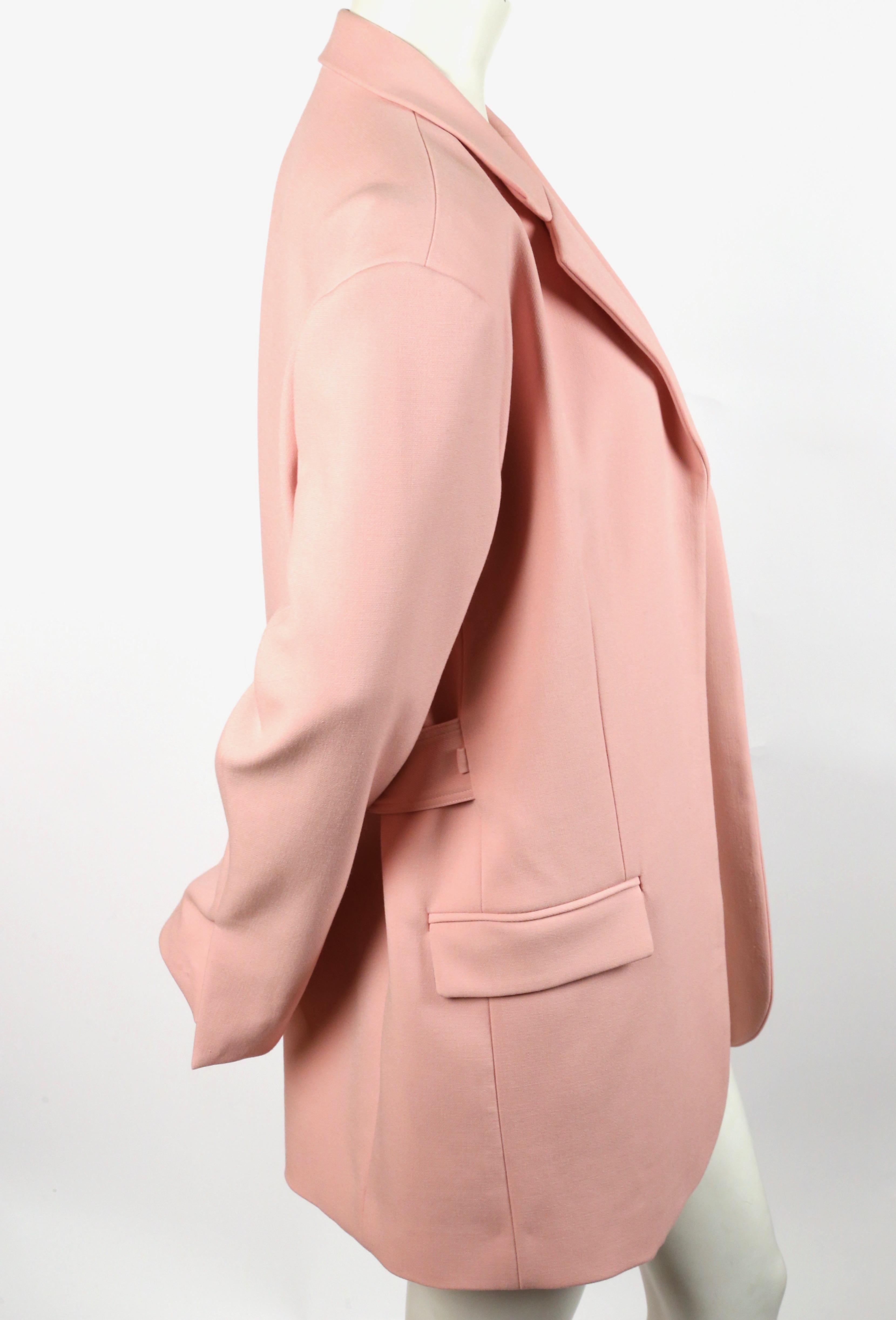 Salmon pink wool blazer with open closure and adjustable half belt designed by Phoebe Philo for Celine. French size 38 (although size/content label removed). Approximate measurements: shoulder 18