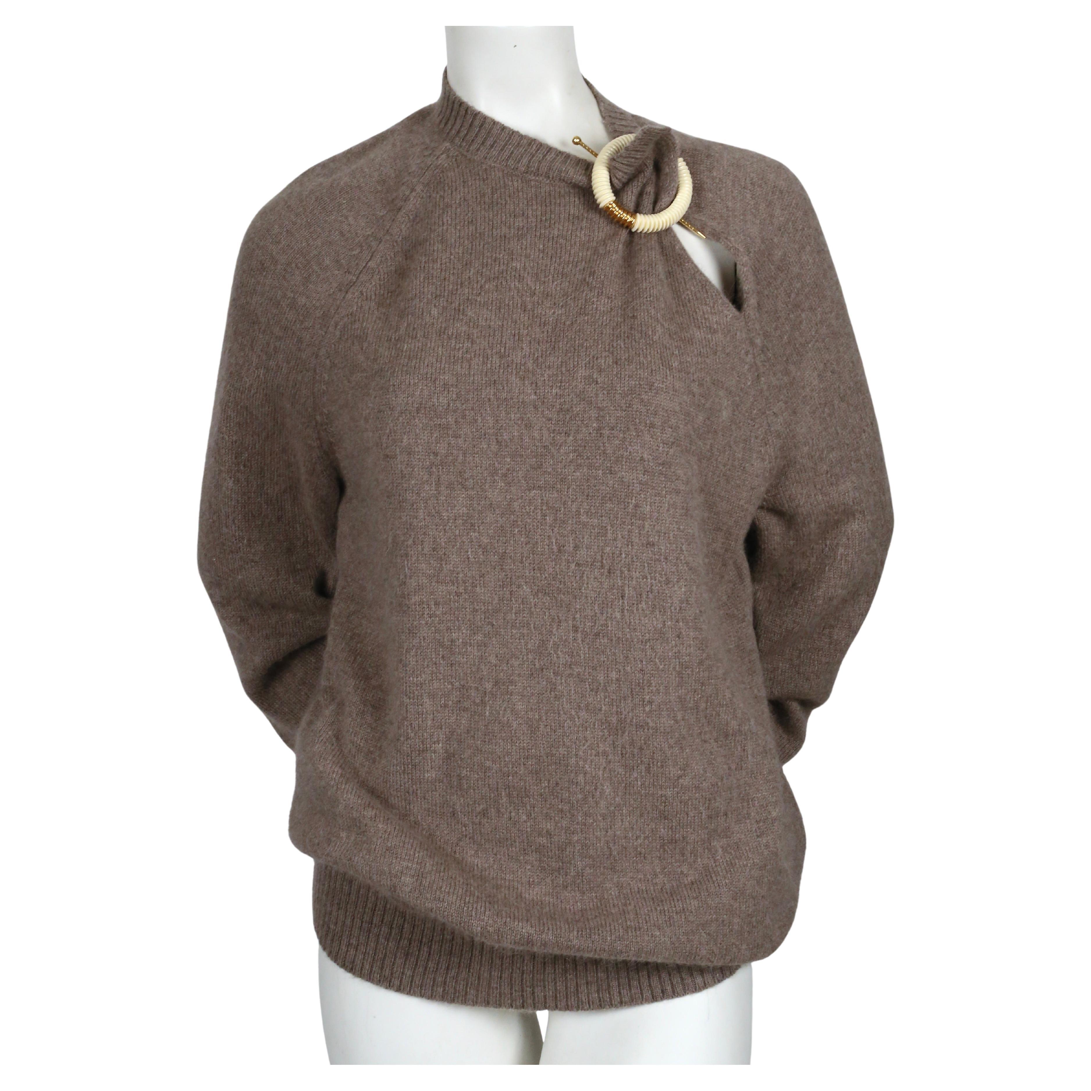 Fuzzy, taupe sweater with decorative brooch designed by Phoebe Philo for Celine dating to fall of 2018. Labeled a Size S but also fits other sizes due to oversized cut.  Approximate measurements (unstretched): bust (pit to pit) 38