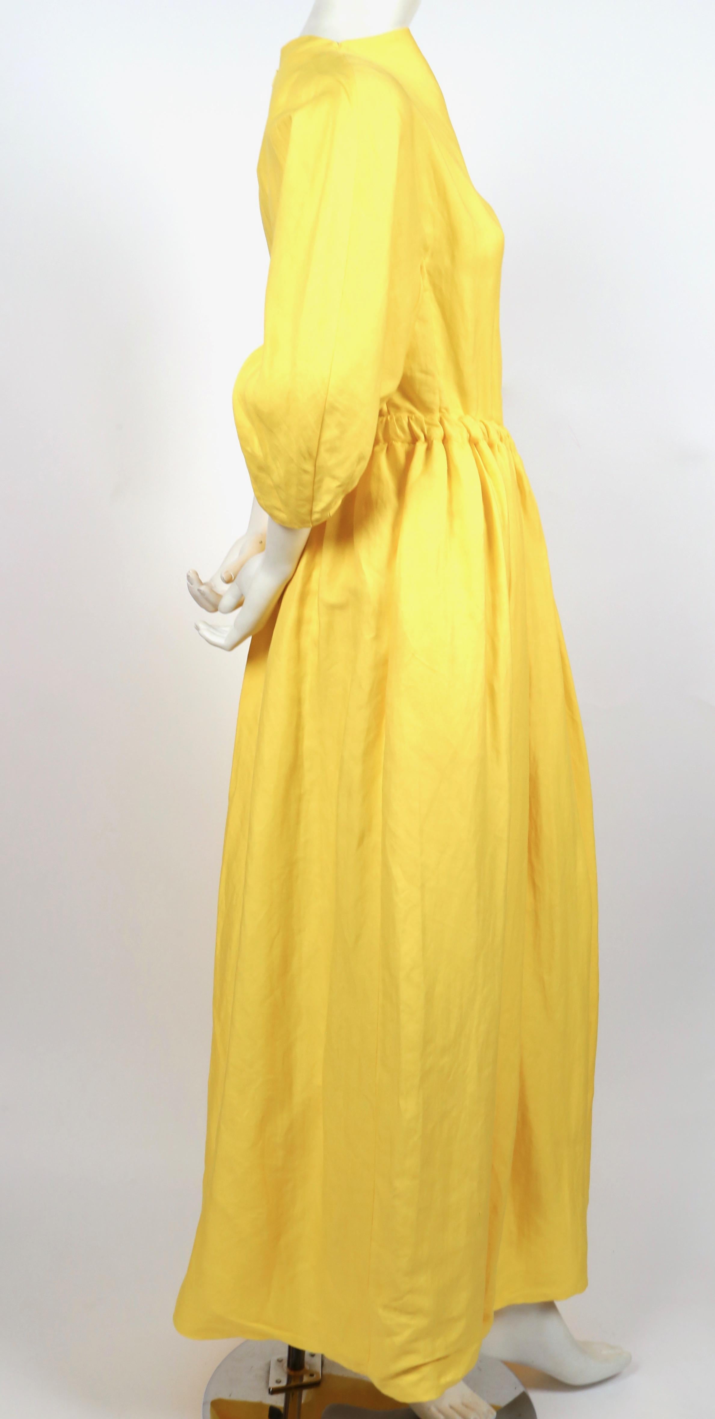 Vivid, yellow linen maxi dress with side cutout detail designed by Phoebe Philo for Celine. Dress is labeled a French size 36. Measurements are very difficult to take for this piece however it was not clipped on the size 2 mannequin. Approximate