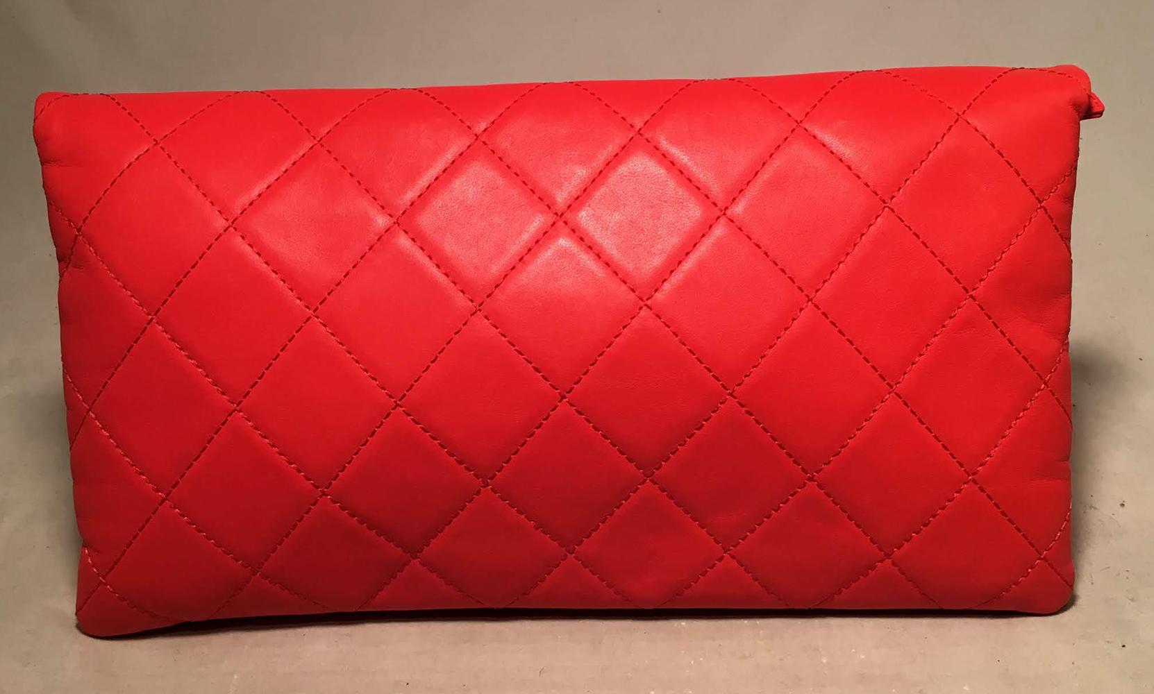 Chanel Red Quilted Leather CC Fold Over Clutch in excellent condition. Bright red quilted leather exterior trimmed with matte gold CC logo hardware along front top fold. Two interior zippered compartments lined with red nylon. No stains, smells or