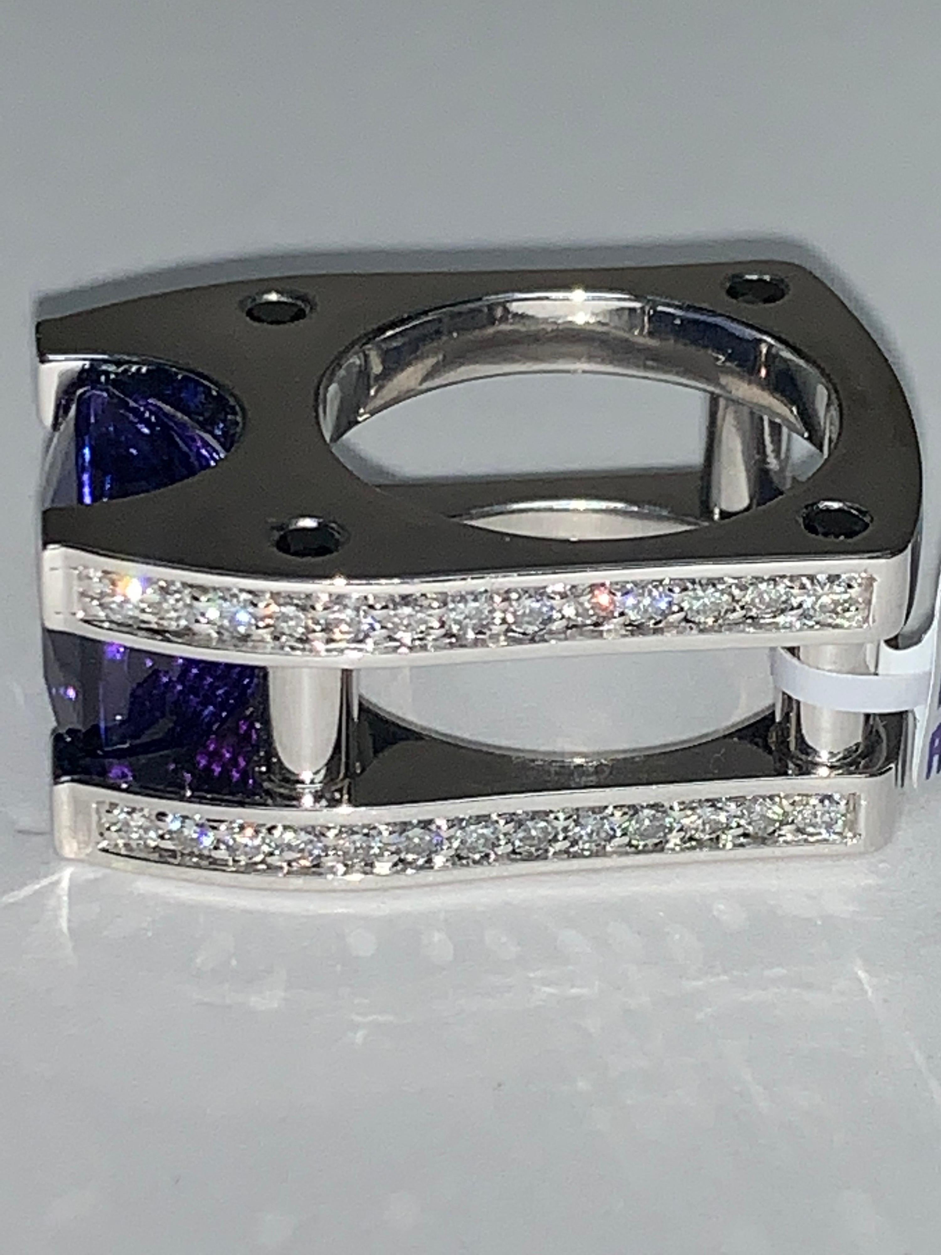 Sophisticated stunning amazing Hand crafted Tanzanite Center Stone that is embellished by white pave diamonds on 2 sides of the 18K White Band.  This one-of-a-kind ring is nothing like you will ever see again.  

20.18 Carat Tanzanite
1.62 Carat