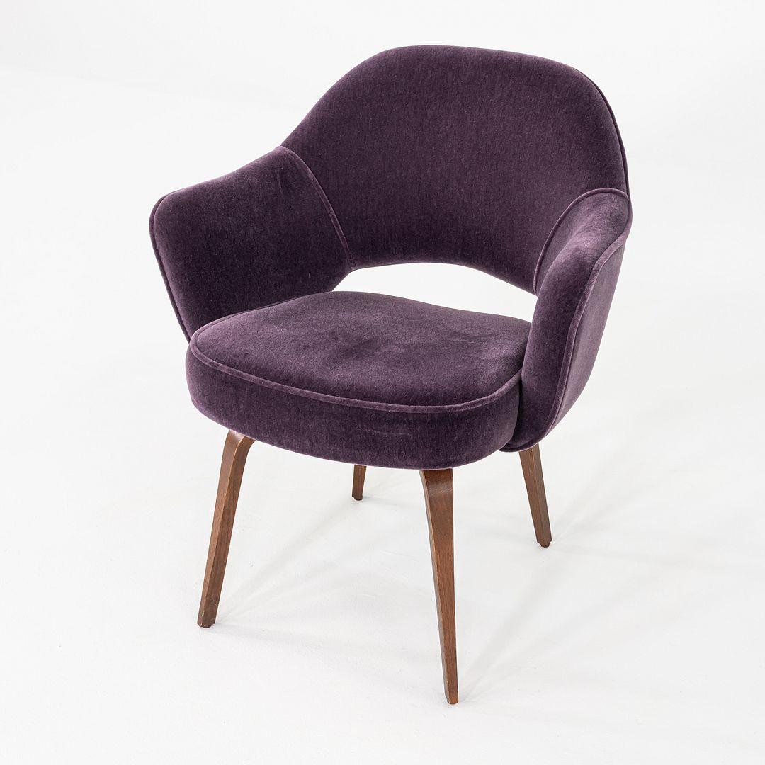 This is a Saarinen Executive Armchair, designed by Eero Saarinen for Knoll International in 1950. This example was produced in the USA in 2018. The chair features upholstered seats in purple Knoll Velvet, and their legs are formed of steam-bent wood