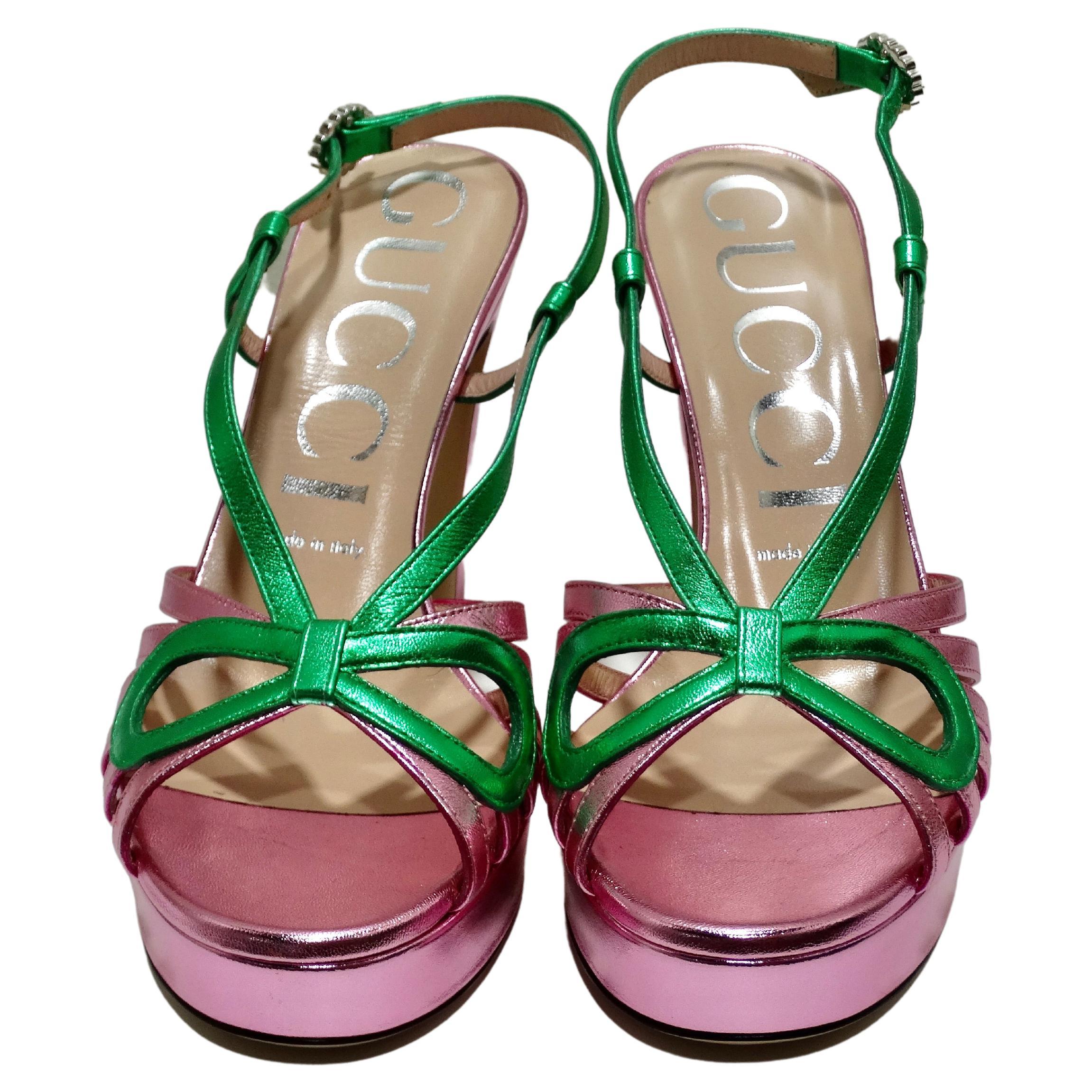 2018 Holiday Edition Gucci Pink Green Metallic Leather Crossed Bow Thick Heel. Reminiscent of styles worn in the 1920s and '30s, the cutout sandal is reinterpreted on a high-heeled platform. The vintage influenced style in metallic leather has a
