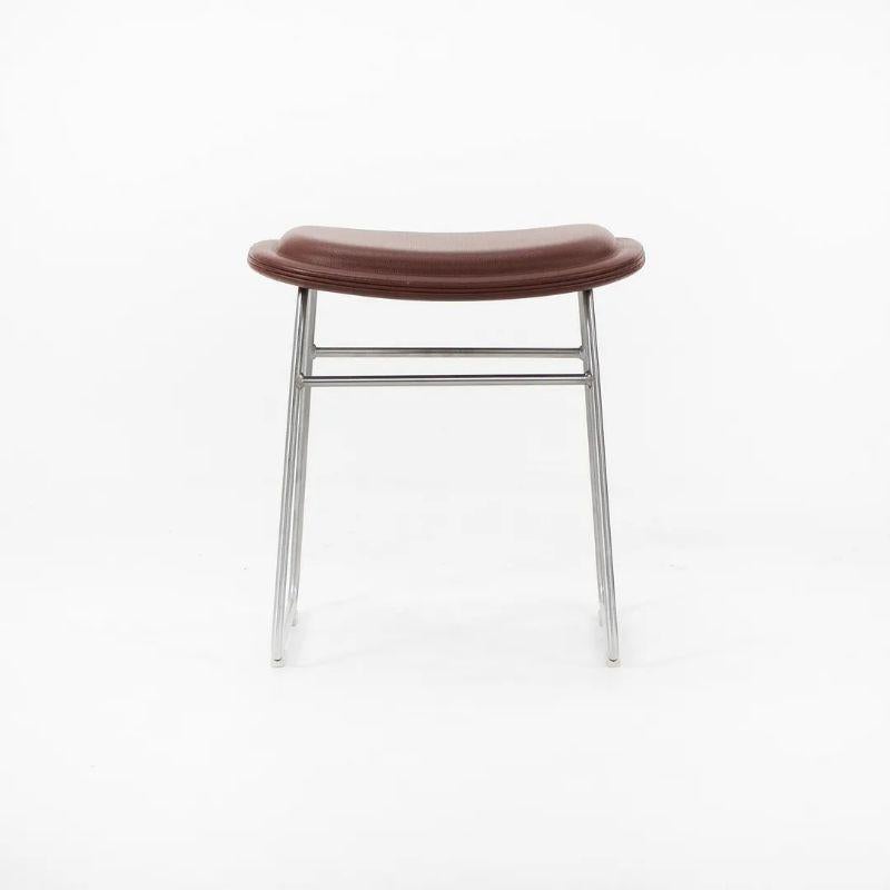 This is a single (six are available, though priced individually) Hi Pad Low Stool, designed by Jasper Morrison for Cappellini in 1999. It features a solid stainless steel sled base, and has a rich brown leather upholstered seat. Cappellini is an