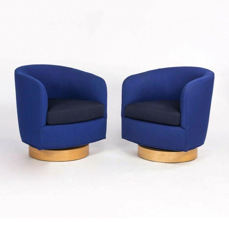 Listed for sale is a single (multiple chairs are available) Papa Roxy swivel lounge chair in blue fabric with black fabric seat cushion and natural wood base, designed by Milo Baughman and produced by Thayer Coggin in North Carolina. The Papa Roxy