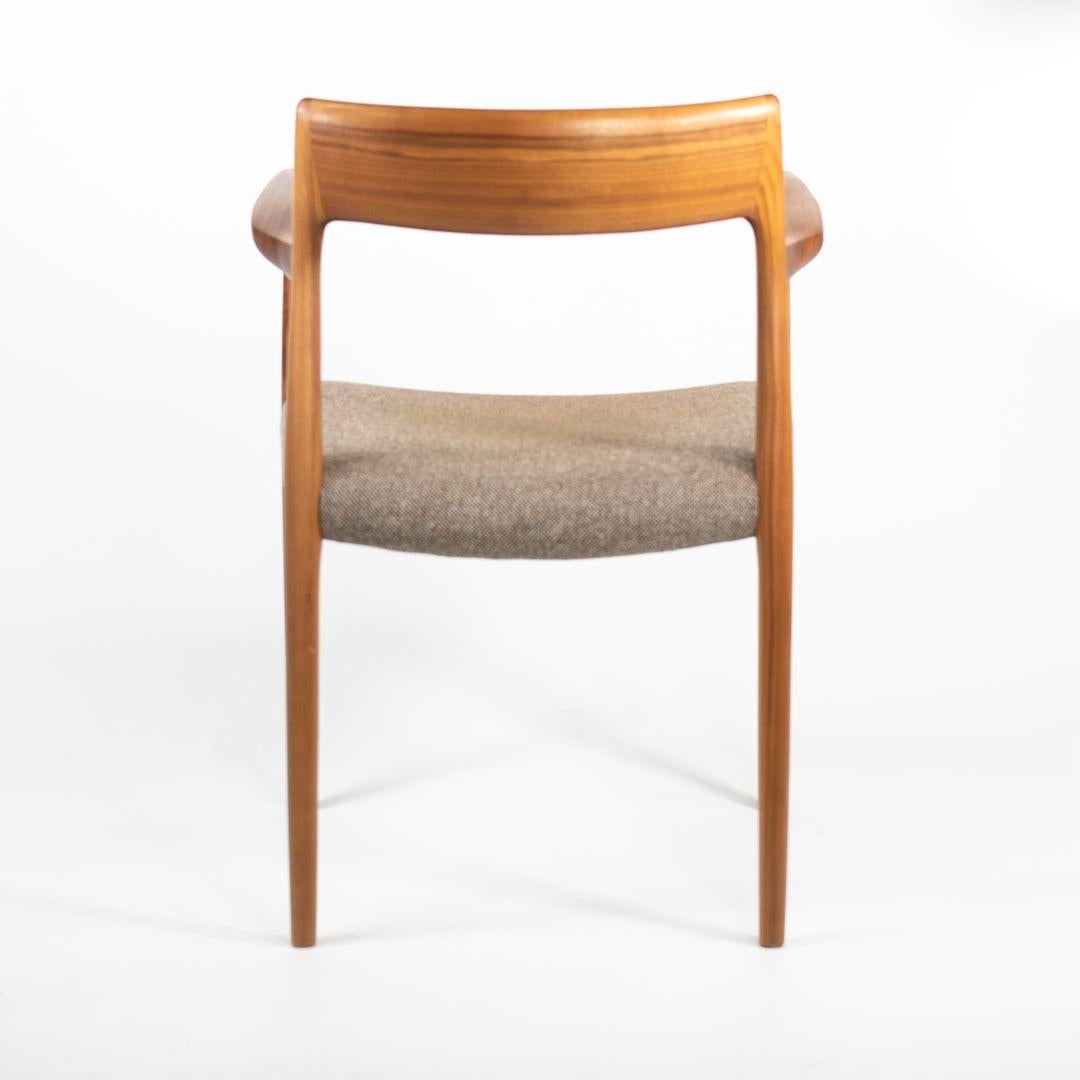 This is a pair of Model #57 armchairs, designed by Niels Moller for J.L. Mollers Mobelfabrik in 1959. These examples date to 2018 and have only been very lightly used. The listed price is for the pair. The chairs are constructed of solid walnut