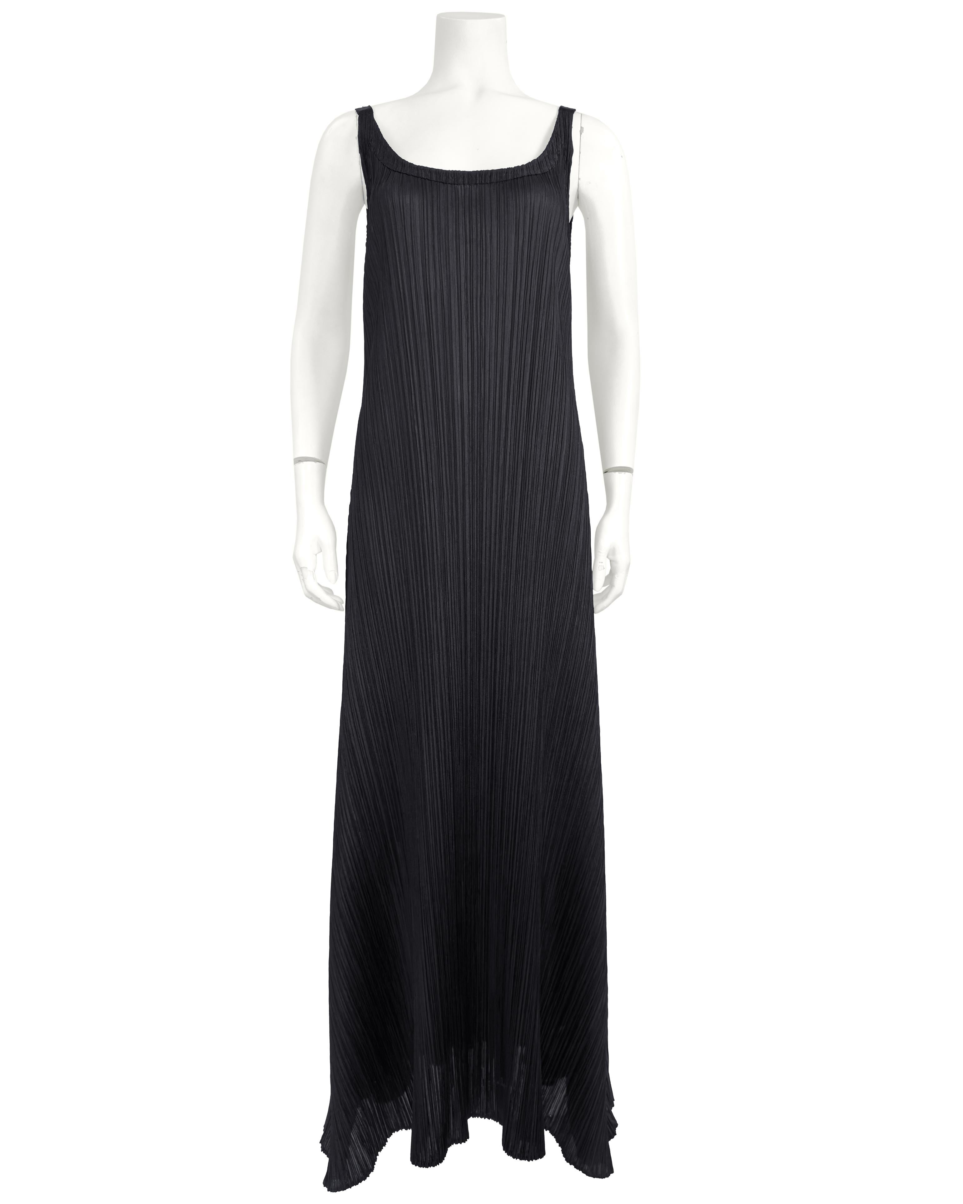 Timeless innovation meets effortless grace in this striking Spring 2018 black plissé set from Pleats Please by Issey Miyake. A masterclass in form and function, the ensemble features a minimal maxi dress and an asymmetrical open-front jacket - both