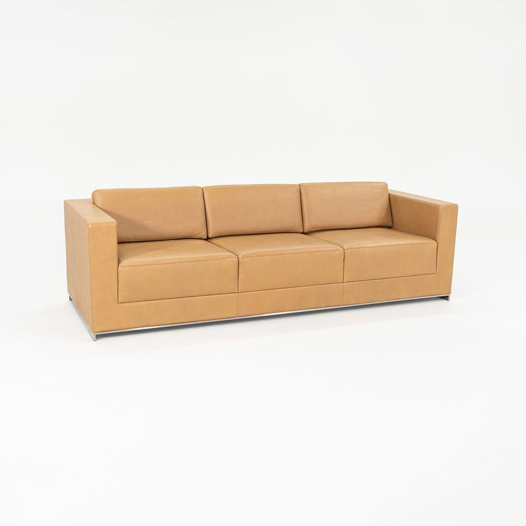 This is a B.1 Three Seat Sofa, initially designed by Fabien Baron for Bernhardt Design in 2013. This particular example dates to 2019 and was produced in the USA. The design features a brushed nickel-plated steel base, and has thick padded boxy foam