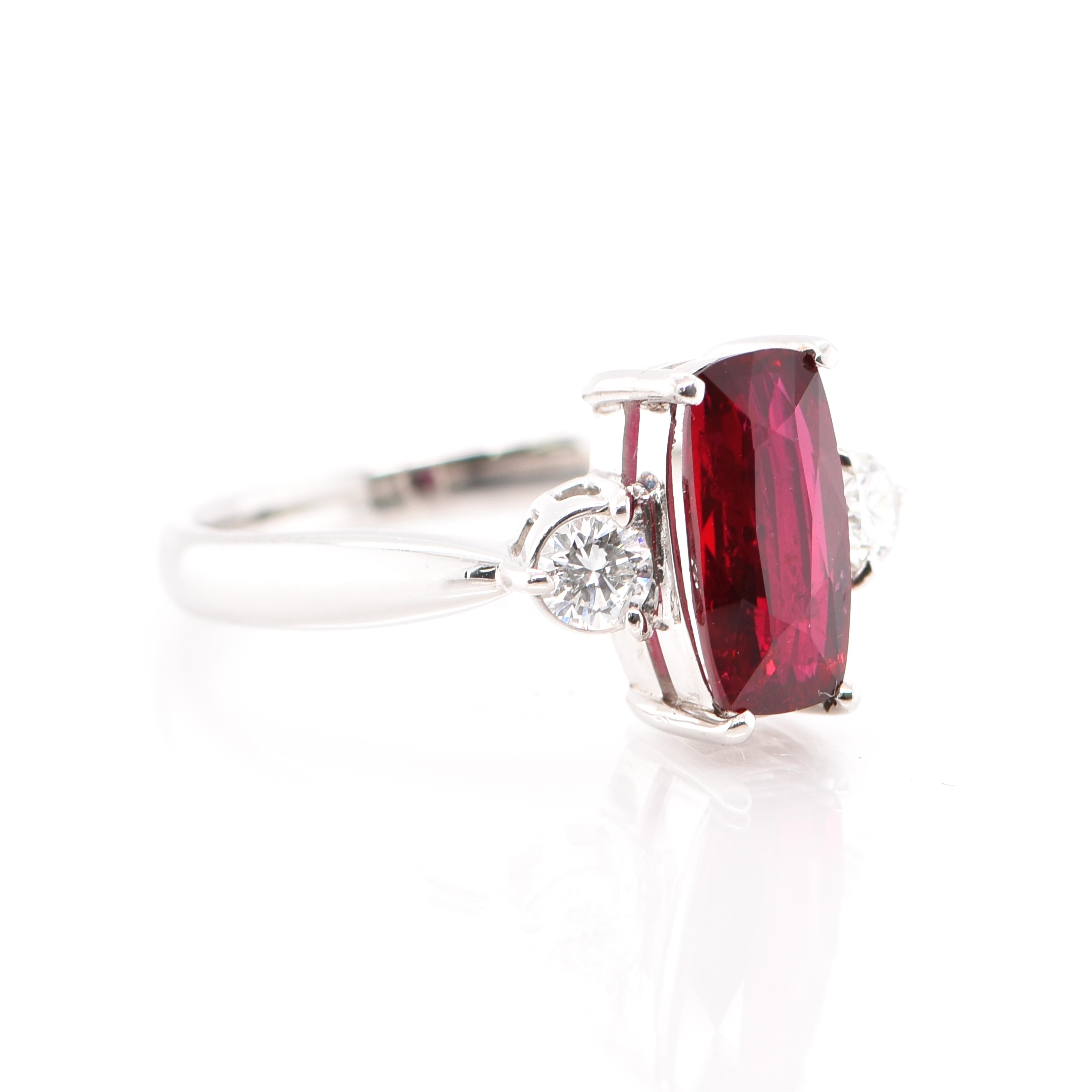A beautiful Engagement Ring featuring a GIA Certified 2.019 Carat No Heat (Untreated) Ruby from Mozambique, Africa and 0.96 Carats of Diamond Accents set in Platinum. Rubies are referred to as 