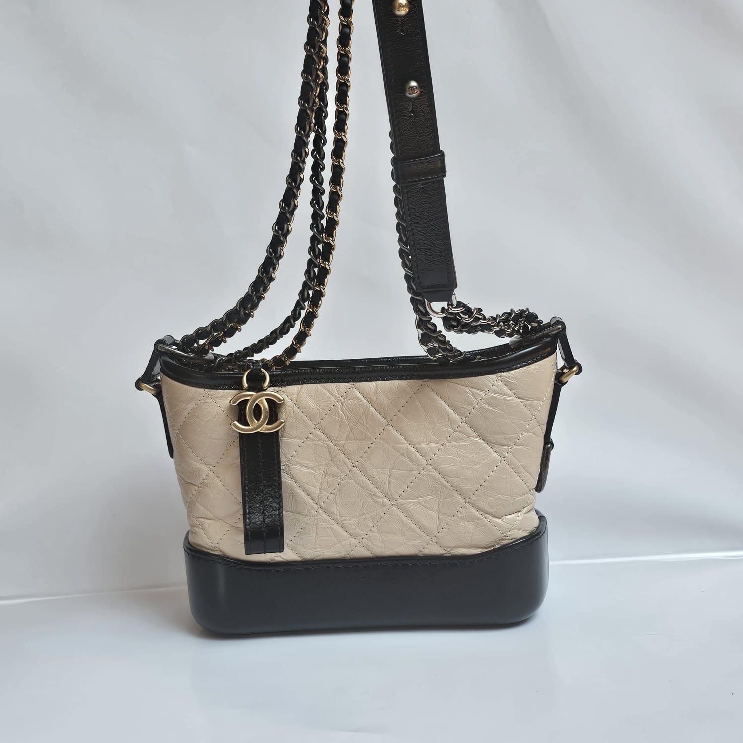 Classic chanel gabrielle in size small. Beige crinkled calfskin leather. Some dryness on the leather surface, but nothing significant. Minor dents and scratches on the body leather. Comes with its holo and card only. Series 28.