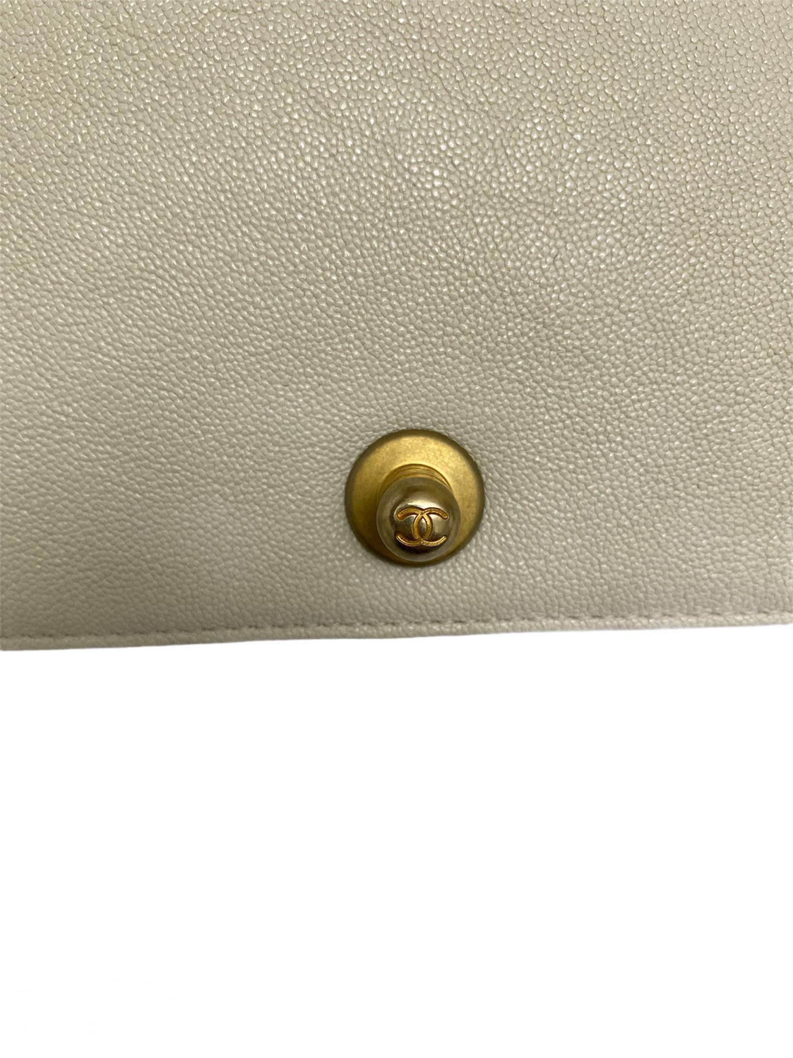 white chanel boy bag with gold hardware