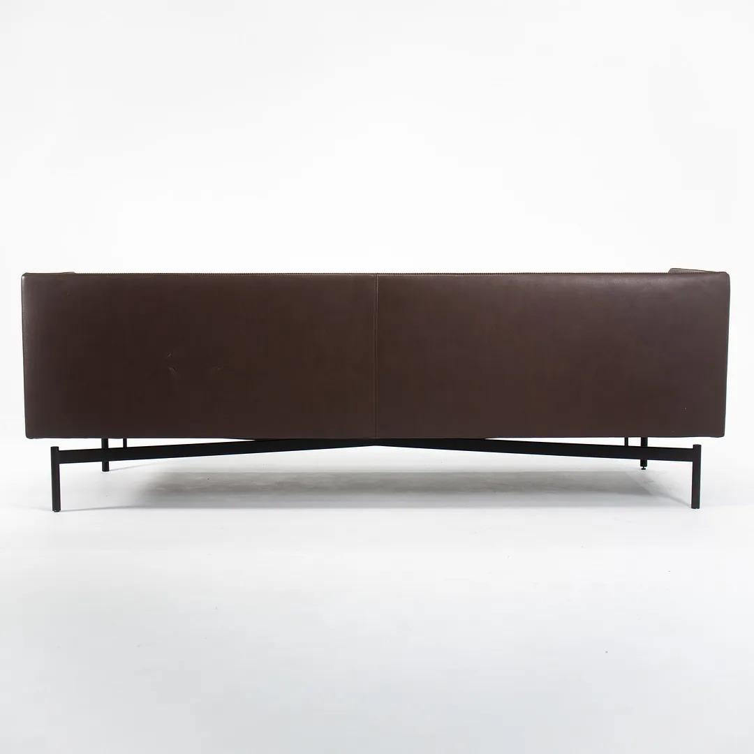 This is a Finale sofa in brown leather with black base designed by Charles Pollock and produced by Bernhardt Design. Charles Pollock is perhaps most famous for his furniture produced by Knoll during the 1960s, however, this line was introduced a few