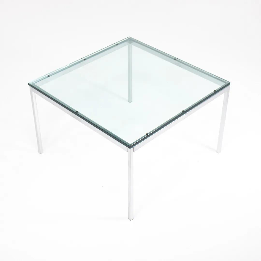 This is a glass and satin chrome end table, model 2515T, designed by Florence Knoll and produced by Knoll Studio. It was produced circa 2019 and was rarely used. 

Florence Knoll approached design with the larger space in mind. Her table collection,