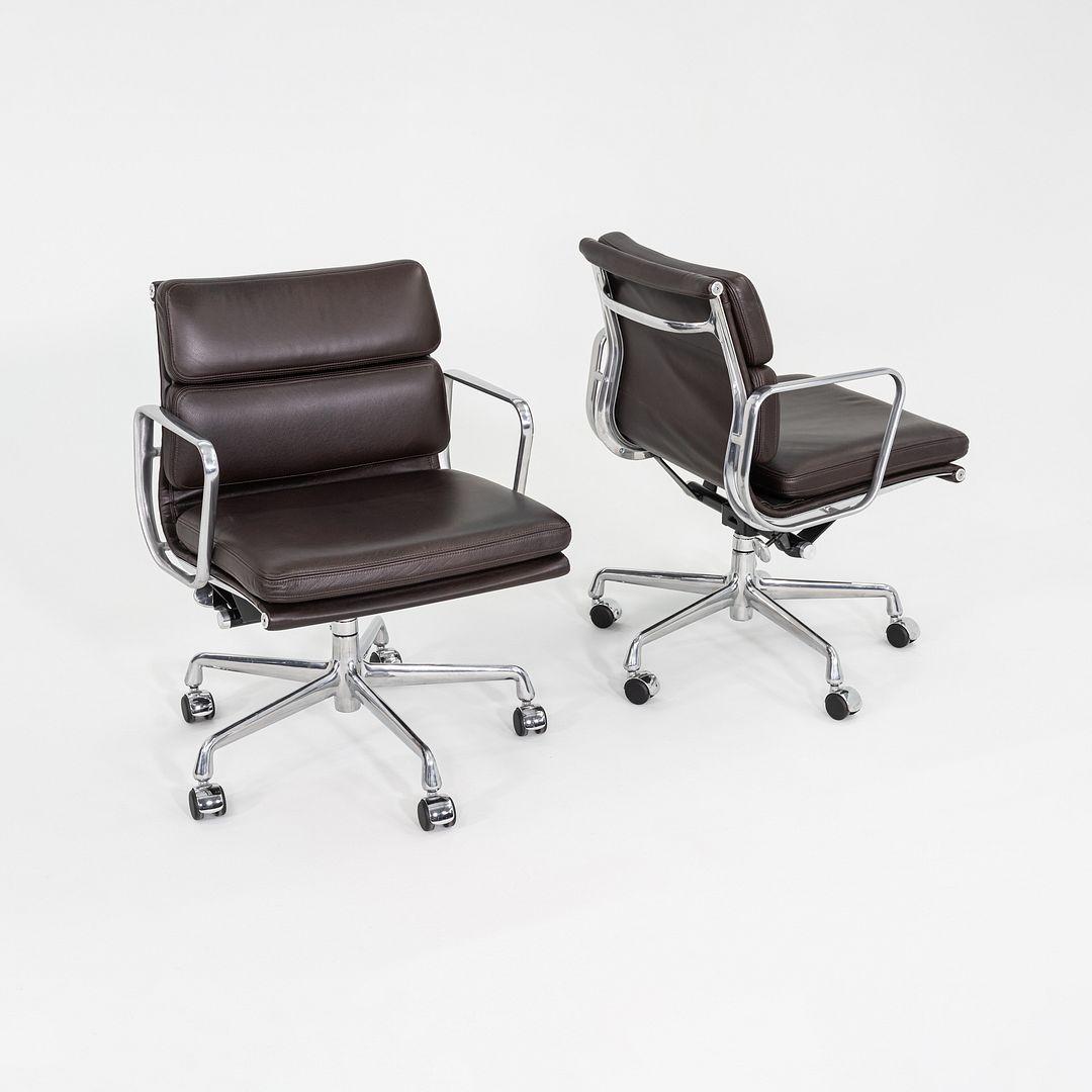 This is an Eames Aluminum Group Soft Pad Management Desk Chair, Model EA435, originally designed by Charles and Ray Eames for Herman Miller in 1969. These examples date to the year 2019. The design features a cast aluminum frame with adjustable