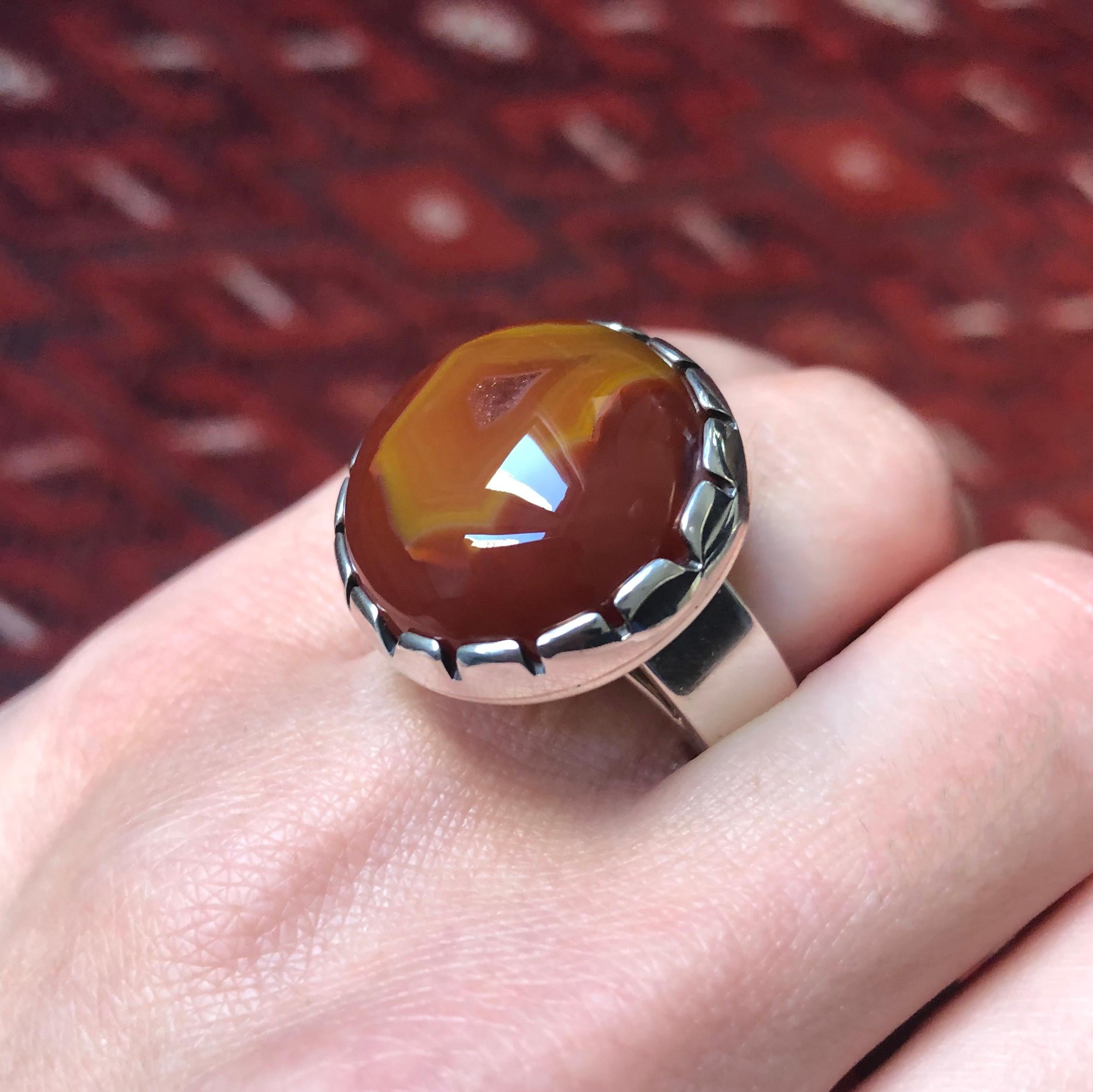 A Condor banded agate and sterling silver ring, by Jared Chavez (San Felipe Pueblo). Stamped with maker's mark. 
This ring is a size 7.50 and cannot be sized. 
Jared  Chavez is a leader among the current generation of Native American artist
