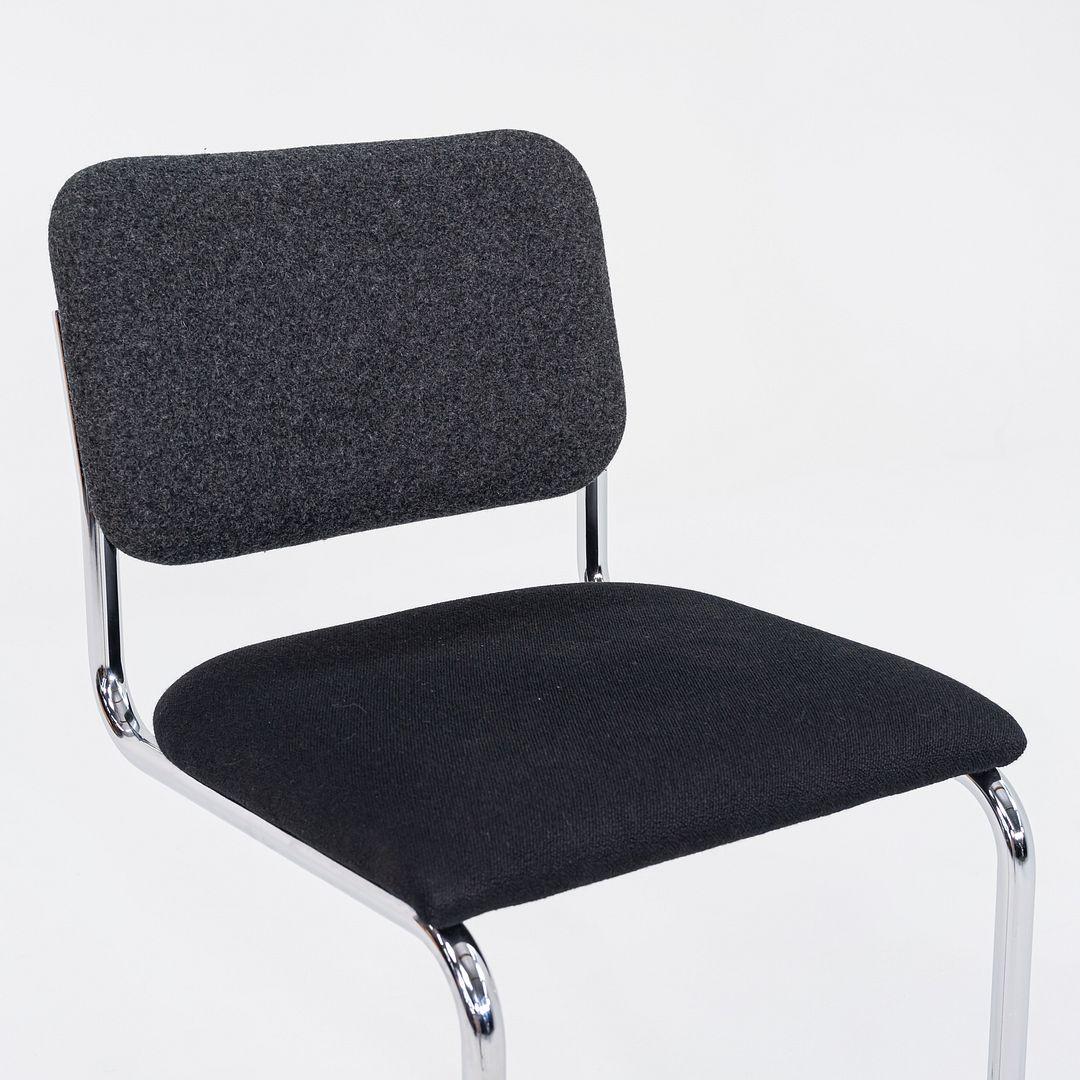 This is a Cesca counter stool, model 51CM, originally designed by Marcel Breuer in 1928. This particular example was manufactured by Knoll in 2019. The design features a tubular chromed-steel cantilever base, and has a molded plywood seat and back.