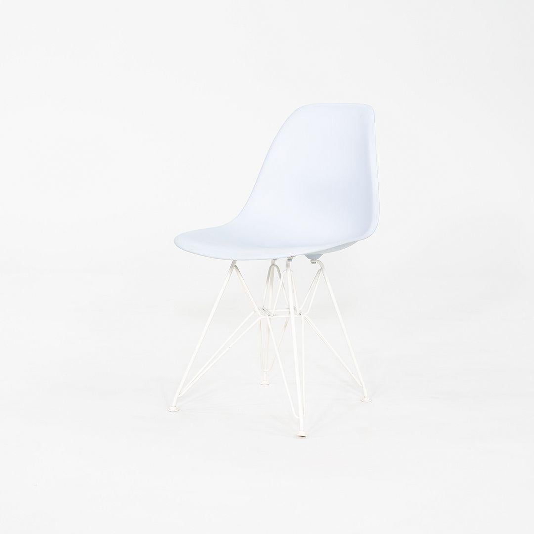 This is a pair of Eames DSR Chairs, originally designed by Ray and Charles Eames in 1951. These particular examples were produced by Herman Miller in the USA in 2017. These chairs feature a molded plastic shell in light blue, and have Eiffel bases