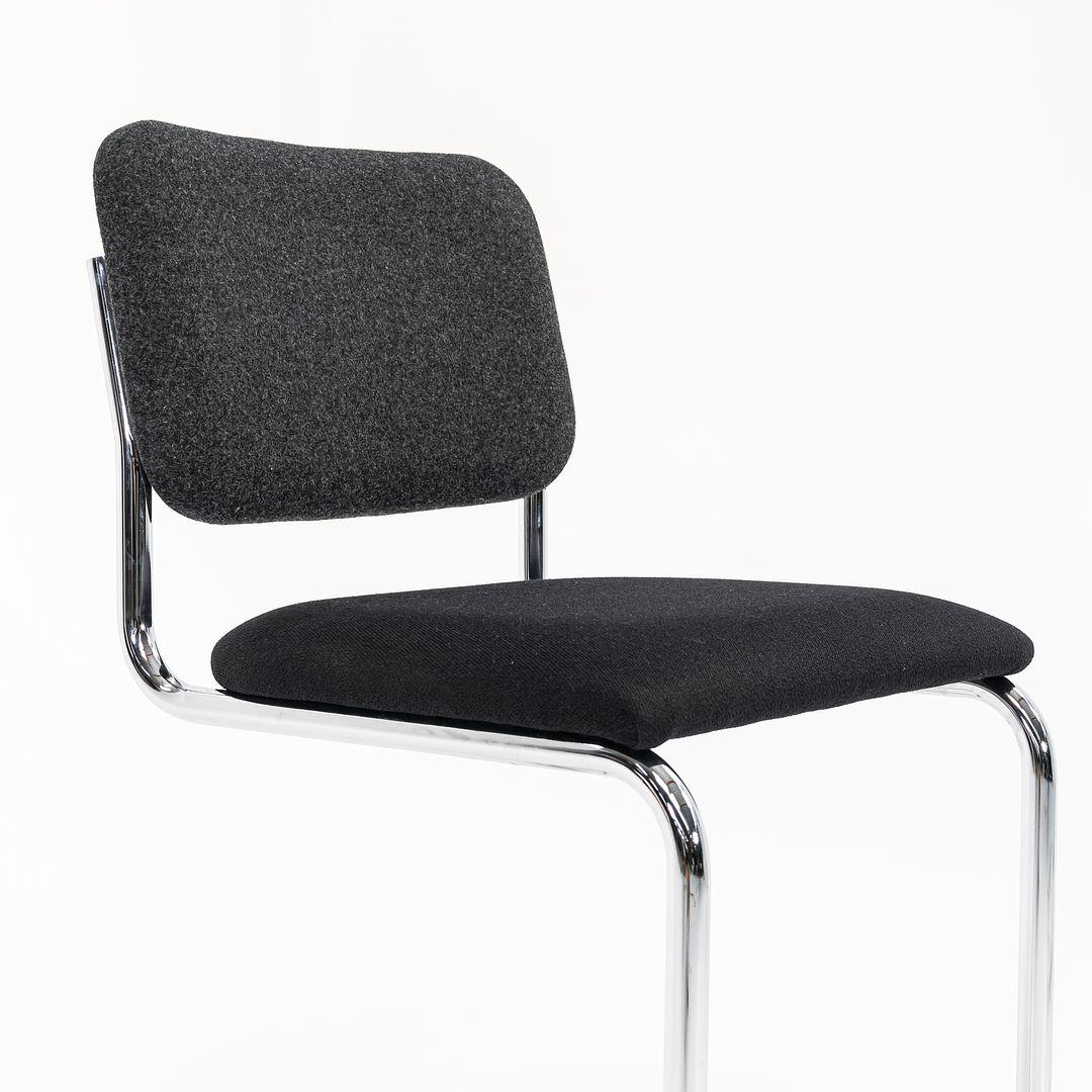 This is a set of three armless Cesca counter stools, model 51CM, originally designed by Marcel Breuer in 1928. The listed price includes three 51CM stools. These examples were manufactured by Knoll in 2019. The design features a tubular
