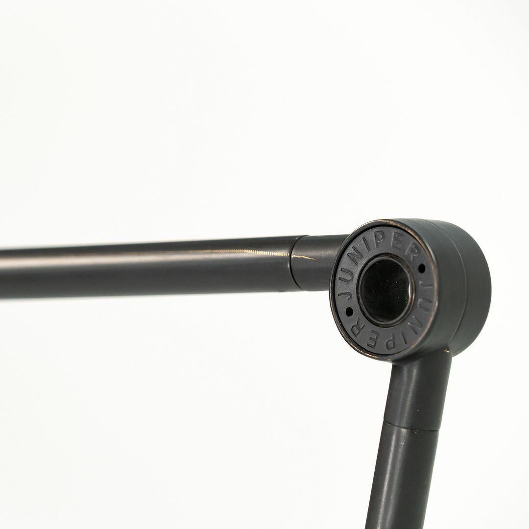 This is a THIN Floor Lamp, designed by Peter Bristol for Juniper design in 2016. This truly thin floor lamp is formed of cast-iron that has a black oxide finish. The minimalist design features an articulating hinge and ball joint at the lamp's base,
