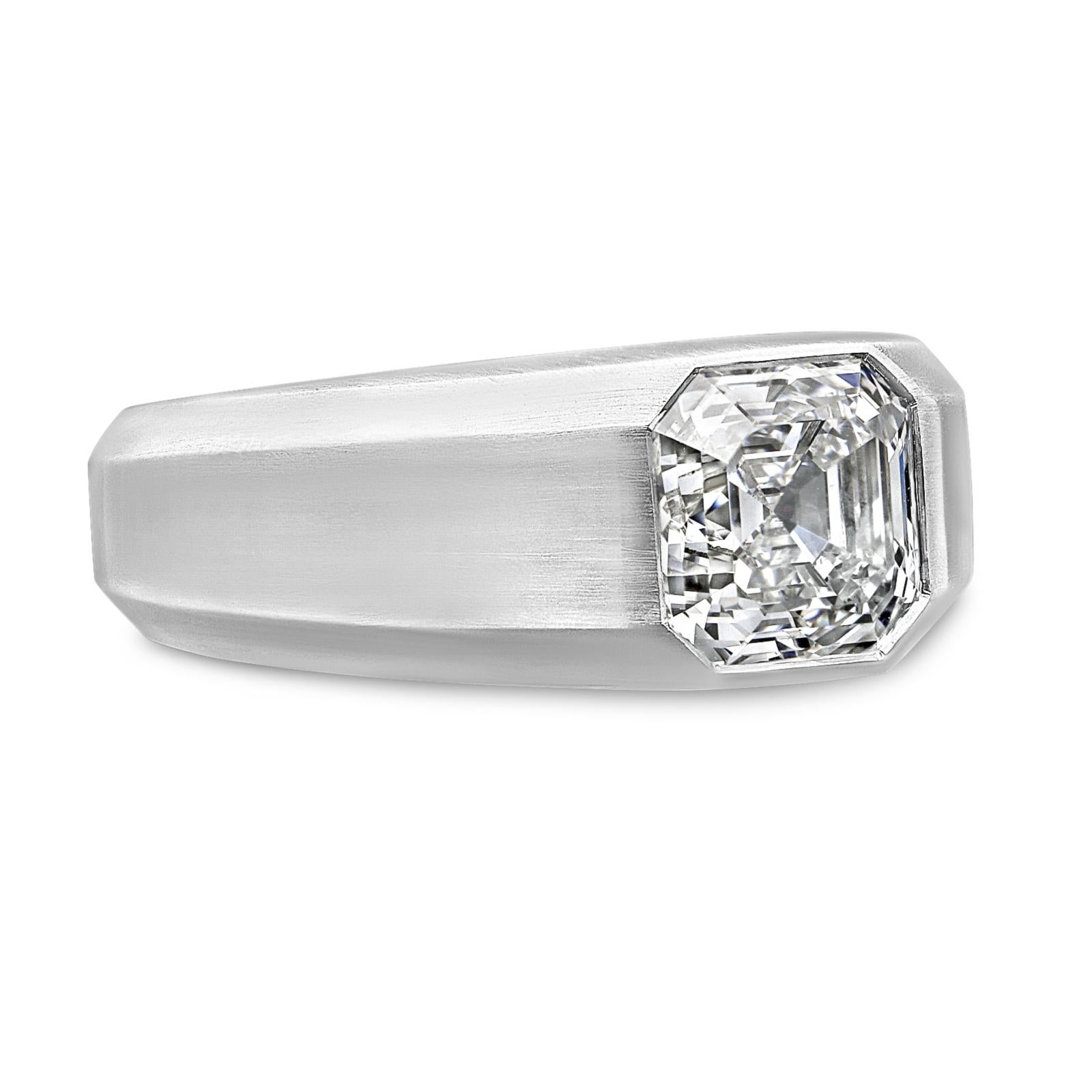 A strikingly modern Asscher cut diamond and platinum ring by Hancocks, centred on a beautiful gypsy set Asscher cut diamond weighing 2.01cts and of F colour and VS2 clarity within a wide tapering hand crafted platinum band with bevelled edges