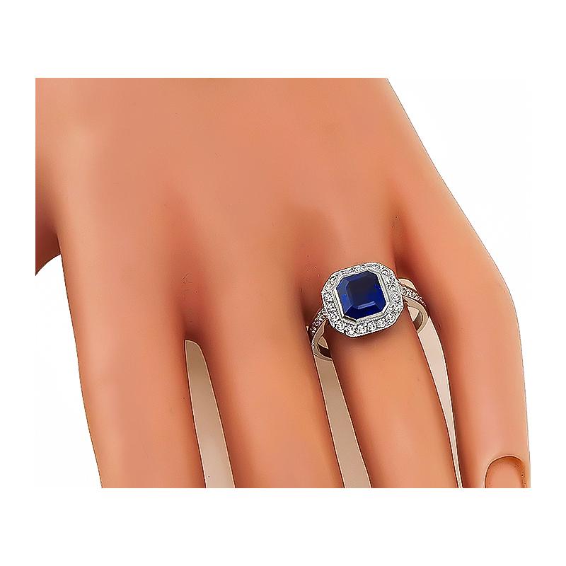 This is a fabulous platinum engagement ring. The ring is centered with a lovely emerald cut sapphire that weighs approximately 2.01ct. The sapphire is accentuated by sparkling round cut diamonds that weigh approximately 0.60ct. The color of these