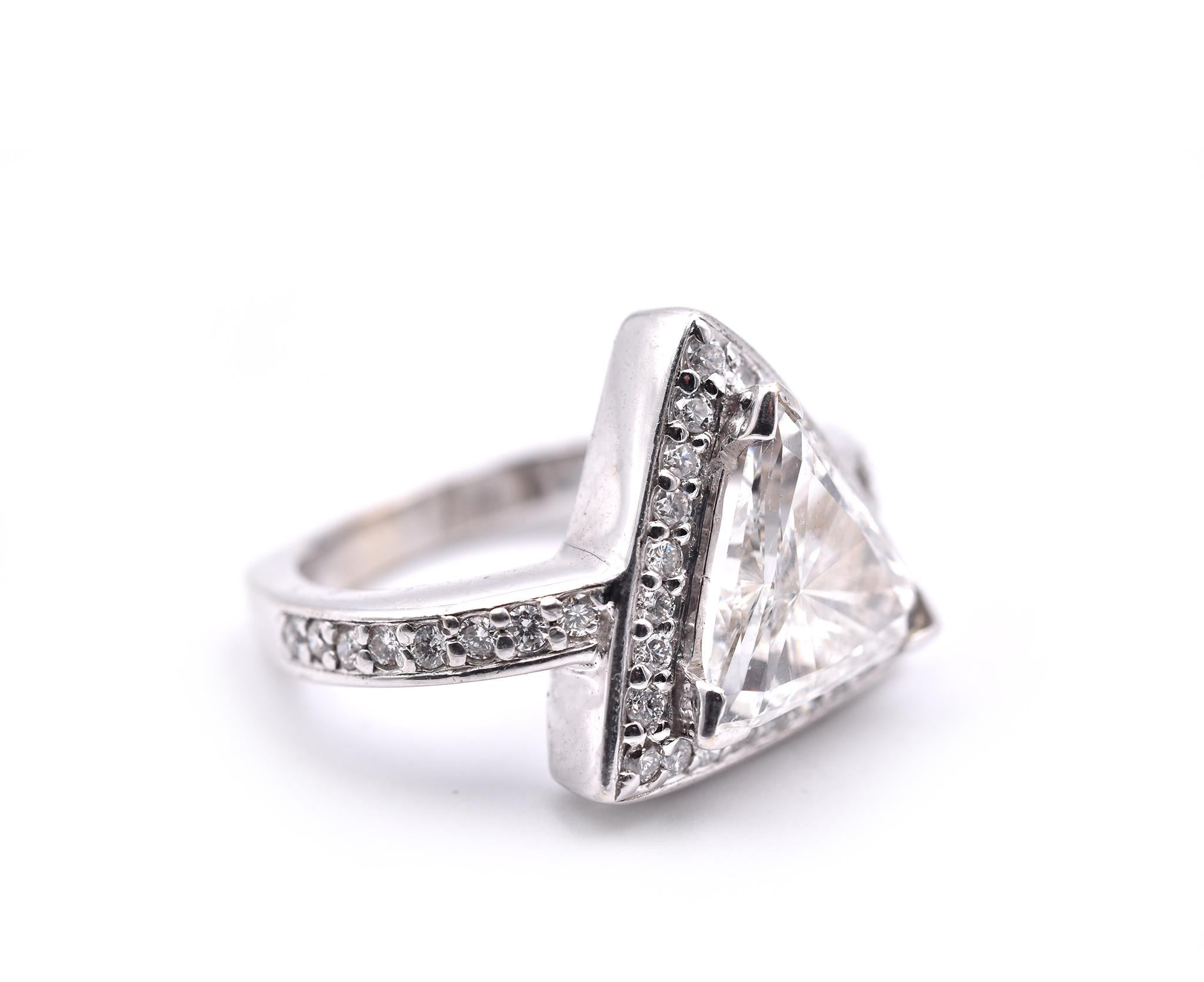 Designer: custom design
Material: 18k white gold with modified Euro shank
Center Diamond: 1 trillion cut= 2.01ct
Color: I
Clarity: SI1
Diamonds: 39 round brilliant cut= .60cttw
Color: G
Clarity: VS
Ring size: 6 (please allow two additional shipping