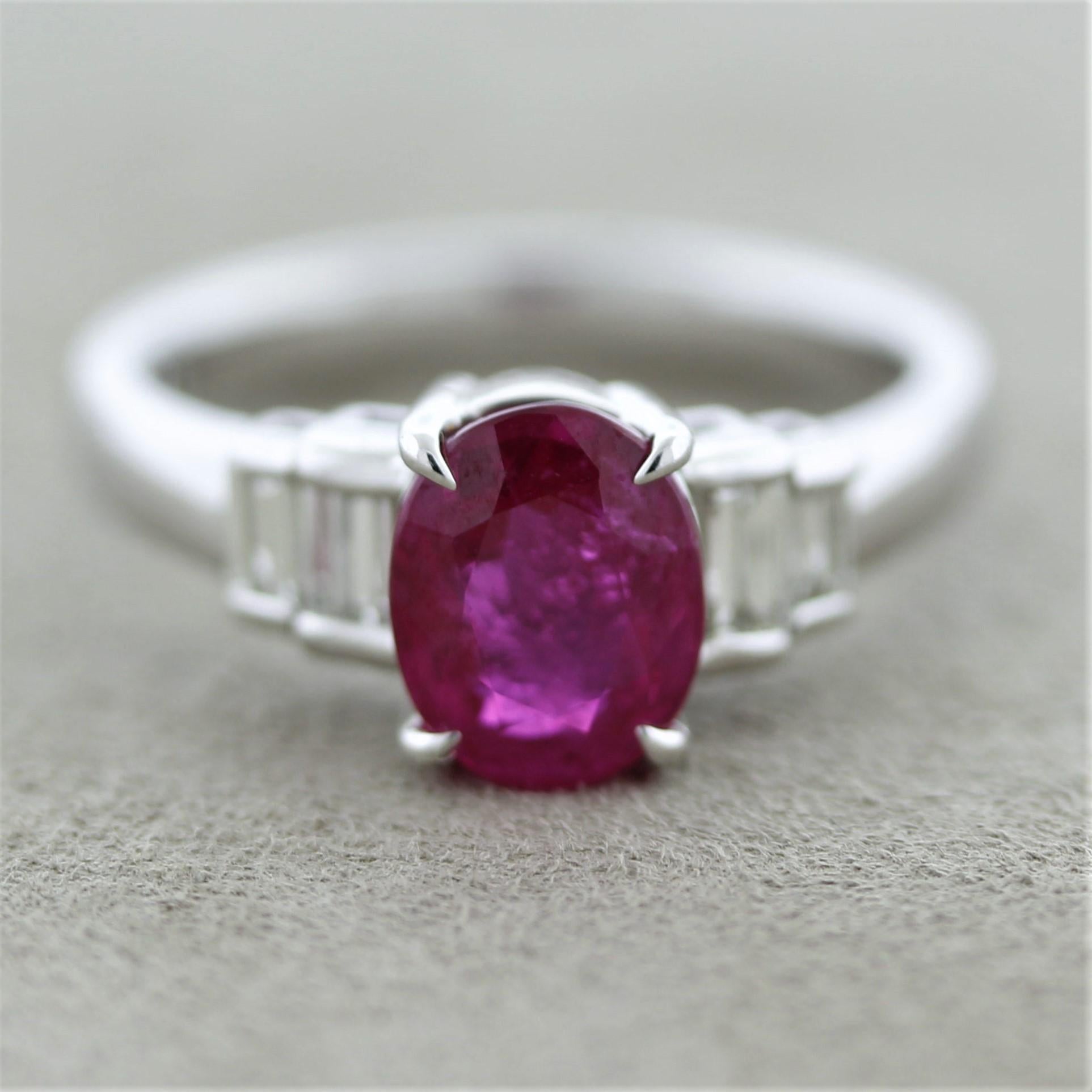 A lovely and classy platinum ring featuring a 2.02 carat natural Burmese ruby! It has a nice oval-shape along with the classic slightly pinkish-red intense color with excellent brilliance and sparkle. It is accented by baguette-cut diamonds set on