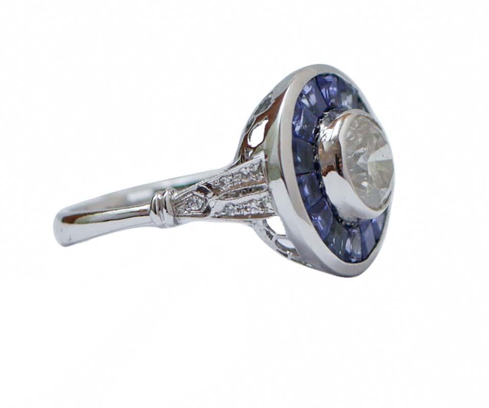 Elegant ring in 14 kt white gold structure mounted with a central diamond surrounded by sapphires. On the stem, little diamonds.
This ring was totally handmade by Italian master goldsmiths and it is in perfect conditions.
Diamonds 0.07 ct
Central