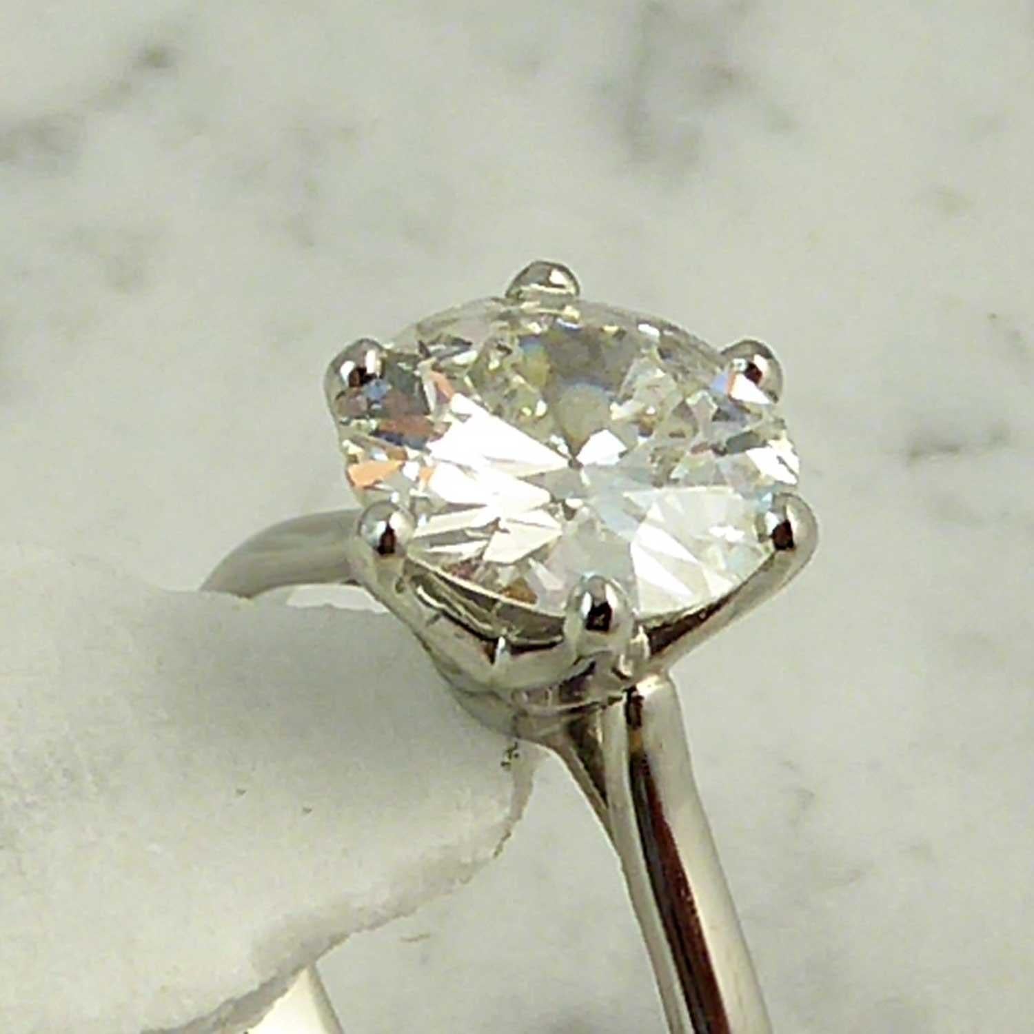 A stunning solitaire diamond ring, 2.02ct, of early round brilliant cut, which has been remounted into a platinum ring in our own workshops (sometimes, old rings have just been loved too much for resale, although the diamond remains as old and