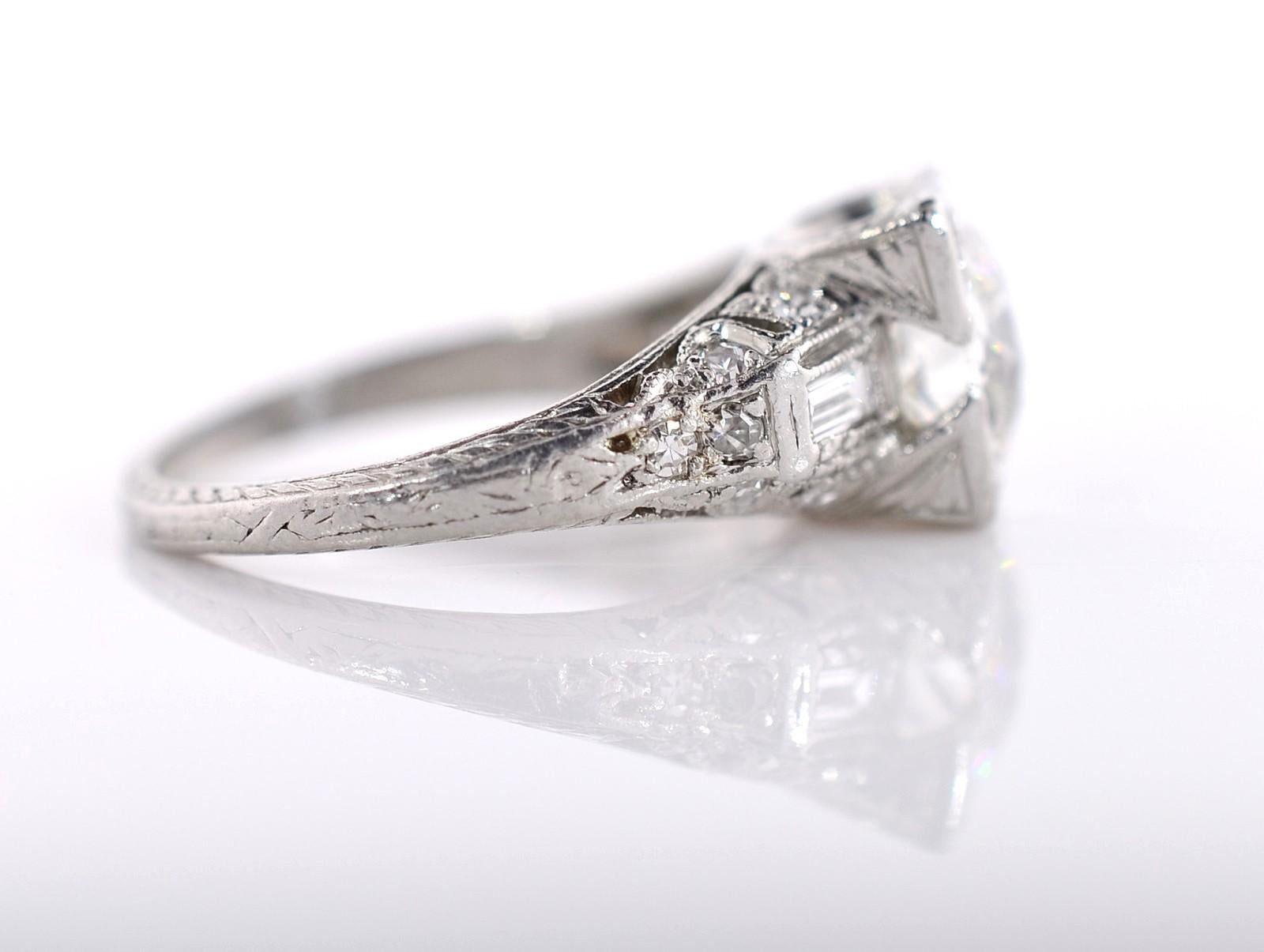 A scintillating 2.02 carat Old European cut diamond nestles in this gorgeously architectural platinum ring. The diamond is J/K color, but with its large, delicious facets, it faces up 2 color grades whiter. The Roaring 20's is embodied here with