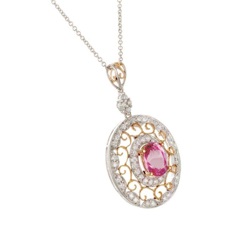Sapphire and diamond pendant necklace. 2.02cts Oval center pink sapphire mounted in an open work 18k rose and white gold frame. The sapphire has a halo of round diamonds with detailed open work wiring of  rose gold and then a larger second halo of
