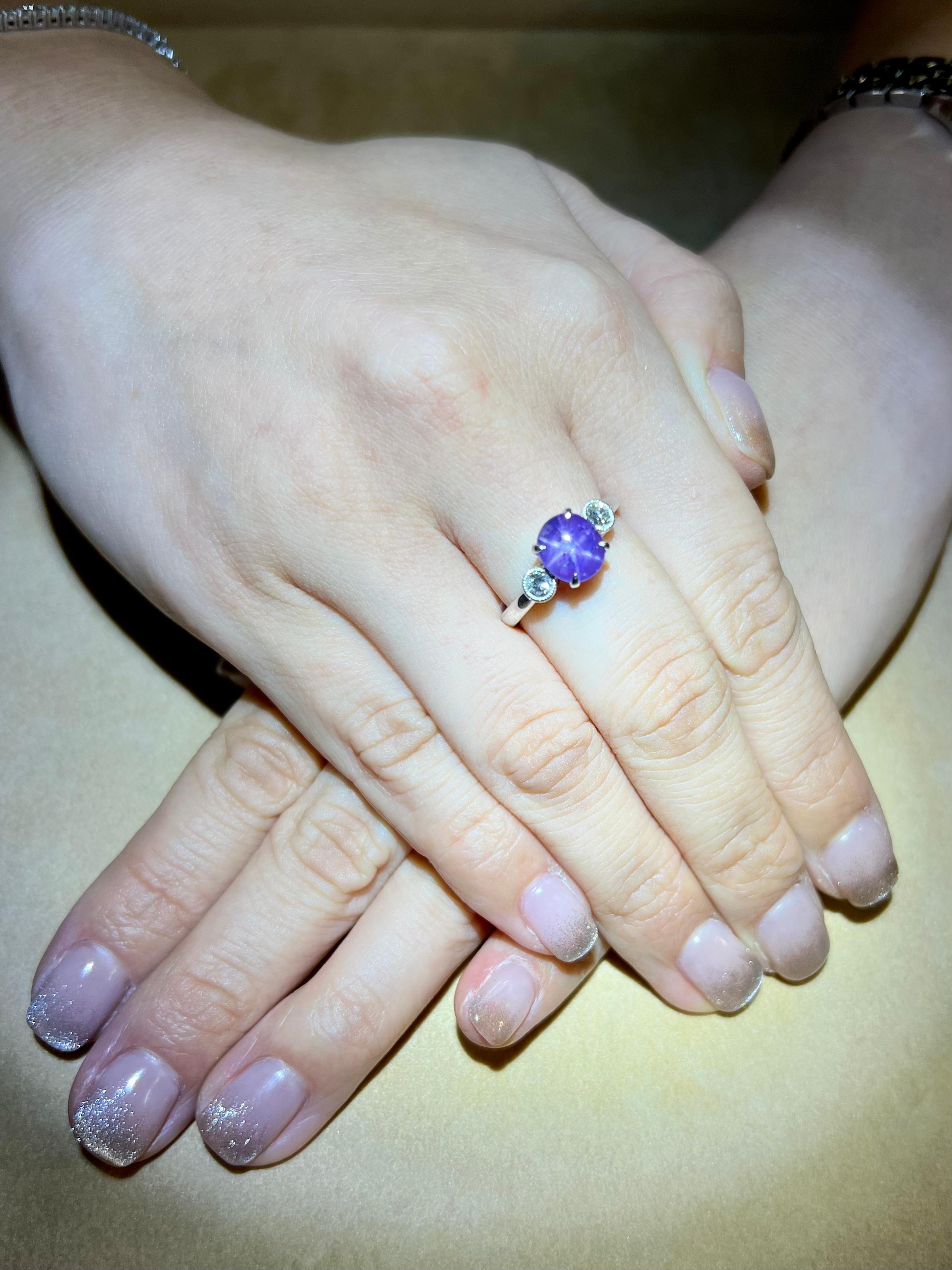 Please check out the HD Video. This 3 stone ring is stunning. The superb natural purple / lavender star Sapphire is beautiful. The ring is set in platinum and diamonds. There are 2 round white diamonds (0.12cts each) totaling 0.24 Cts in this