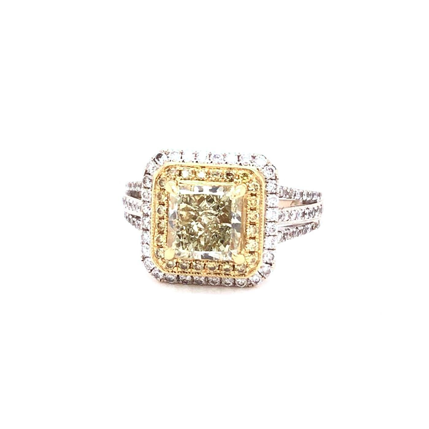 Expertly crafted 18 karats white gold ring with yellow gold accents containing a 2.02-carat prong set Radian cut brilliant natural diamond center stone with 64 pave set natural diamond side stones. The total weight of the 64 diamond side stones is